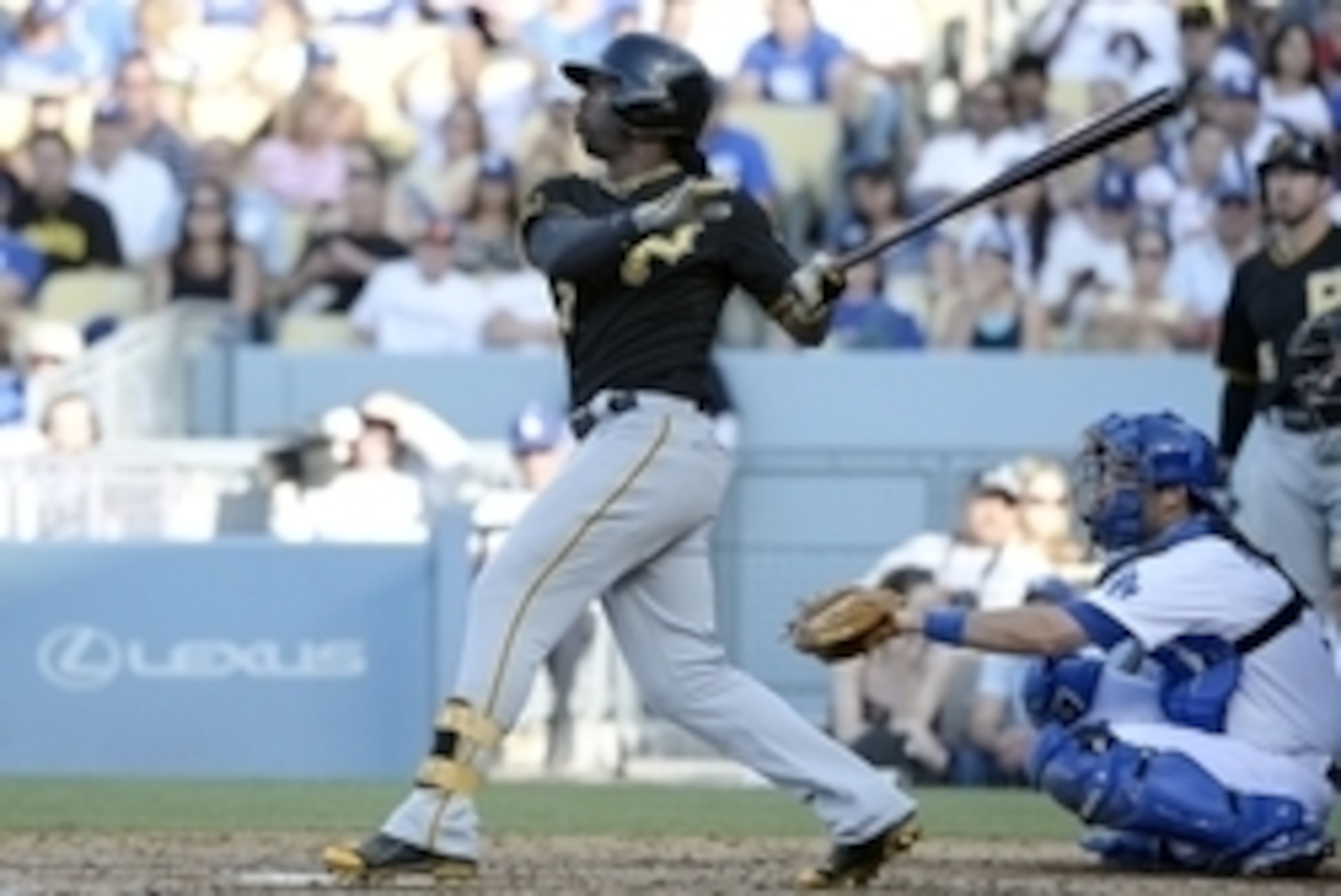 Jun 1, 2014; Los Angeles, CA, USA; Pittsburgh Pirates center fielder Andrew McCutchen (22) hits a solo home run during the third inning against the Los Angeles Dodgers at Dodger Stadium. Mandatory Credit: Richard Mackson-USA TODAY Sports