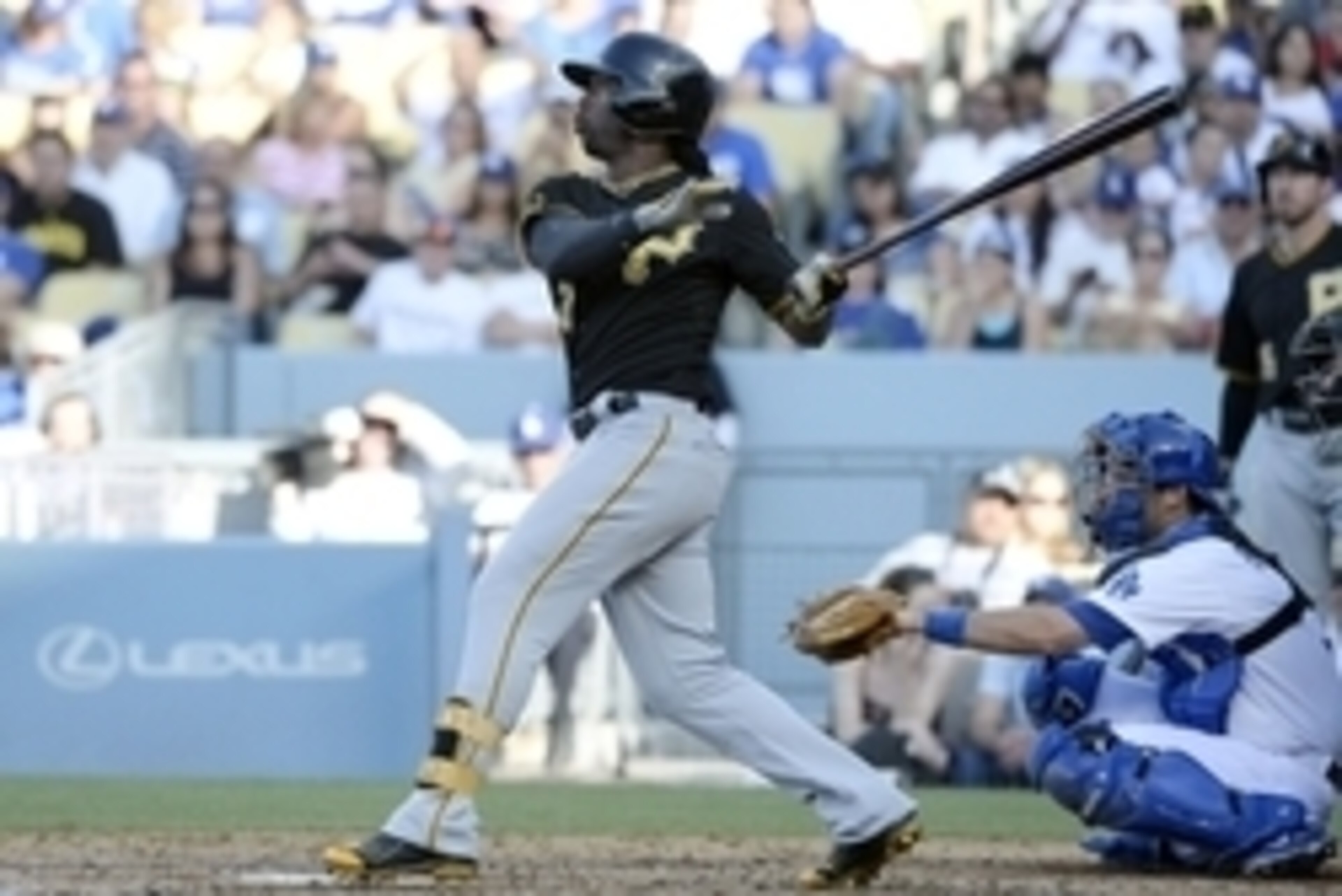 Jun 1, 2014; Los Angeles, CA, USA; Pittsburgh Pirates center fielder Andrew McCutchen (22) hits a solo home run during the third inning against the Los Angeles Dodgers at Dodger Stadium. Mandatory Credit: Richard Mackson-USA TODAY Sports