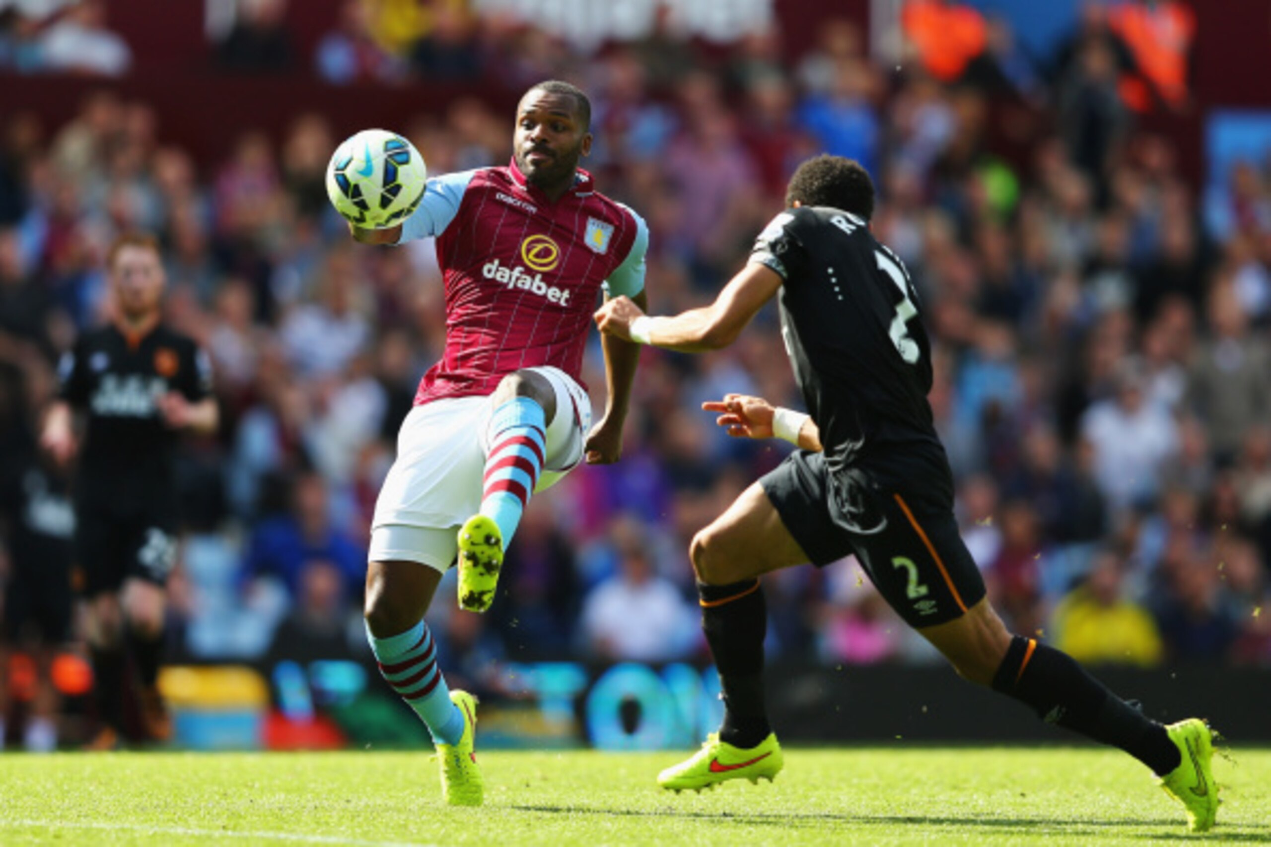 BIRMINGHAM, ENGLAND - AUGUST 31: Darren Bent of Aston Villa is closed down by Liam Rosenior of Hull City during the Barclays Premier League match between Aston Villa and Hull City at Villa Park on August 31, 2014 in Birmingham, England.  (Photo by Clive M