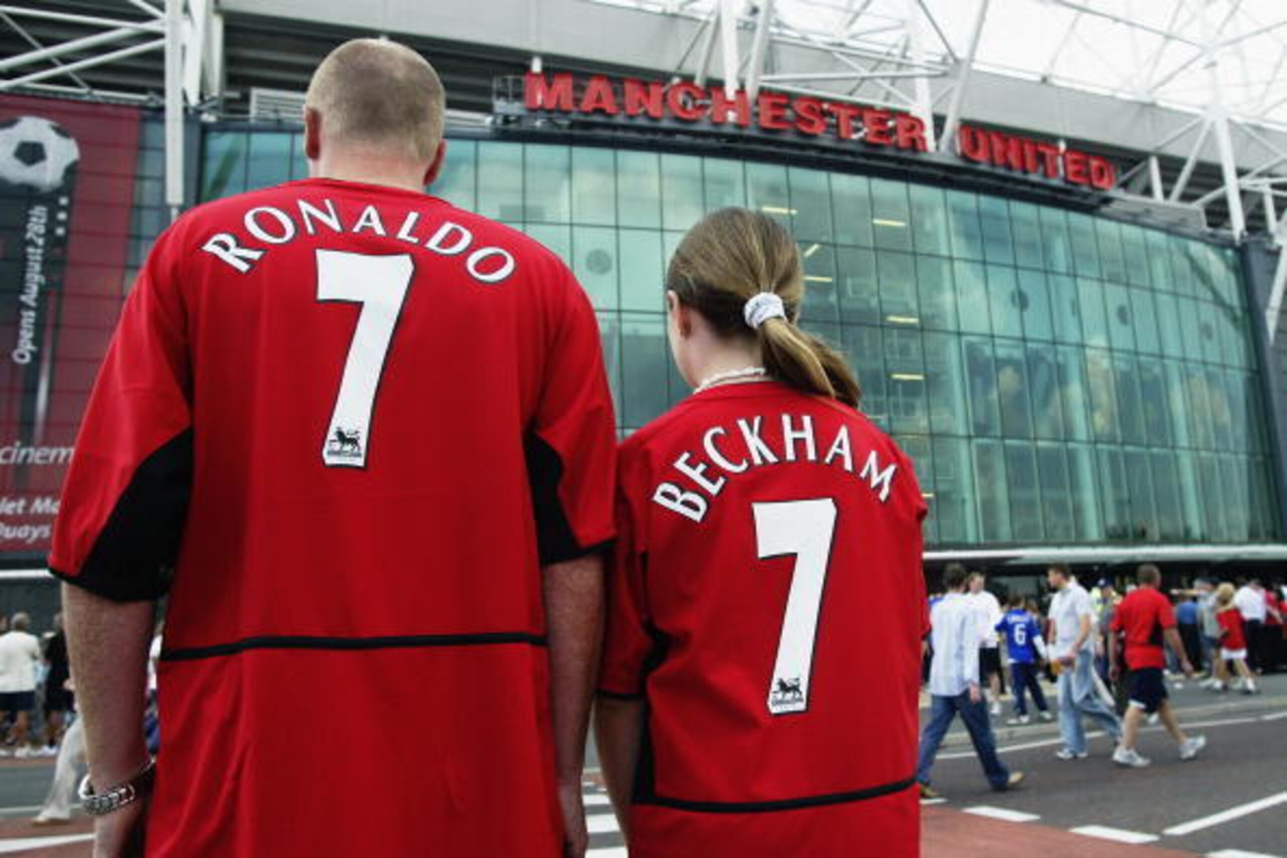 MANCHESTER - AUGUST 16:  Manchester United fans wearing new boy Cristiano Ronaldo and recently departed David Beckham shirts during the FA Barclaycard Premiership match between Manchester United and Bolton Wanderers held on August 16, 2003 at Old Trafford