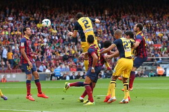 BARCELONA, SPAIN - MAY 17:  Diego Godin of Club Atletico de Madrid scores his goal during the La Liga match between FC Barcelona and Club Atletico de Madrid at Camp Nou on May 17, 2014 in Barcelona, Spain.  (Photo by Alex Livesey/Getty Images)