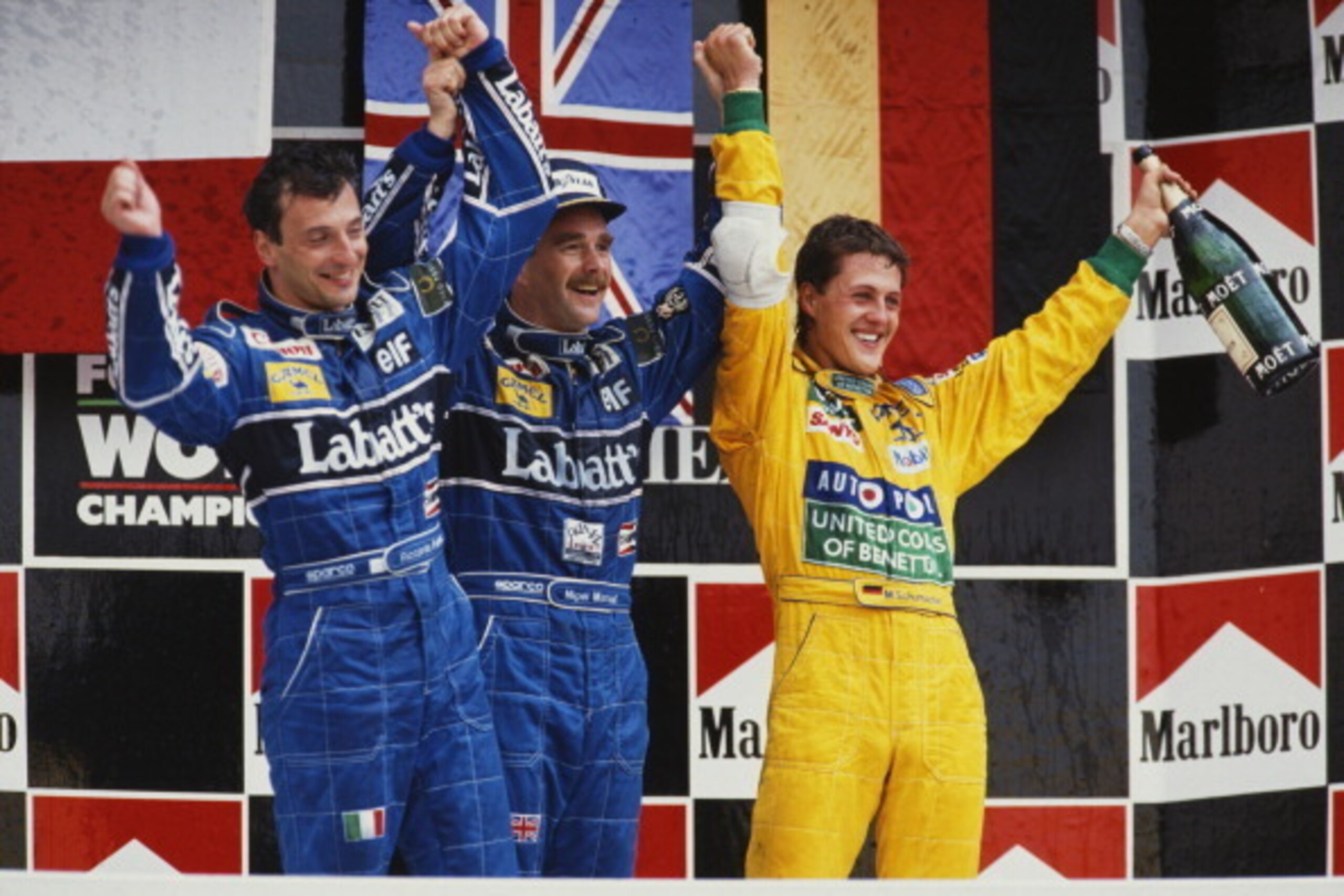 Nigel Mansell of Great Britain (C), driver of the #5 Canon Williams Renault Williams FW14B Renault RS3C/RS4 V10 celebrates winning with 2nd placed team mate Riccardo Patrese and third placed Michael Schumacher (R) during the Mexican Grand Prix on 22nd Mar