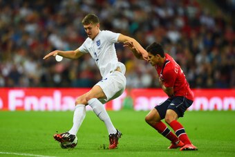 LONDON, ENGLAND - SEPTEMBER 03:  John Stones of England (L) goes past Tarik Elyounoussi of Norway during the International friendly match between England and Norway at Wembley Stadium on September 3, 2014 in London, England.  (Photo by Laurence Griffiths/