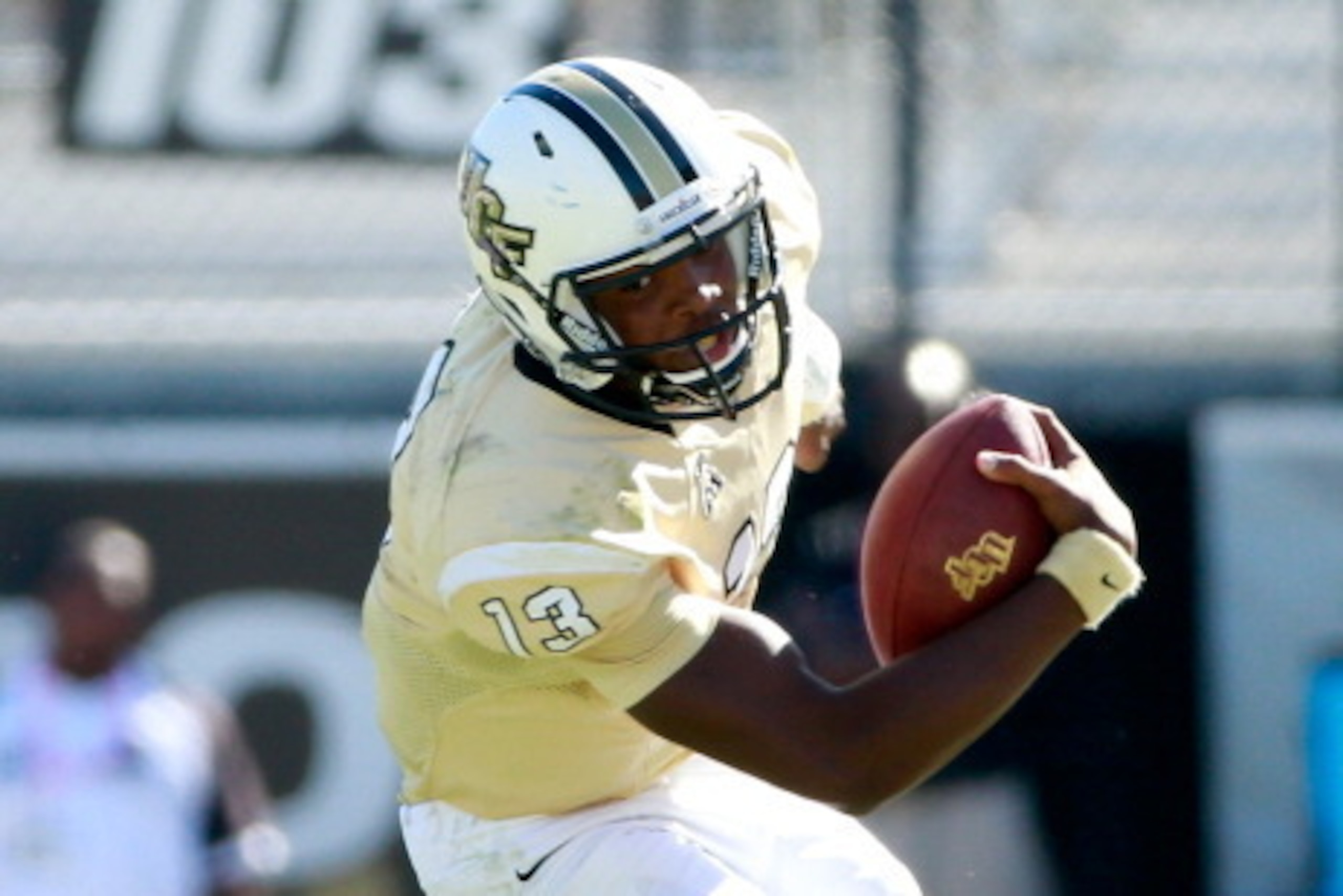 ORLANDO, FL - OCTOBER 26:  Justin Holman #13 of the UCF Knights runs for yardage during the game against the Connecticut Huskies at Bright House Networks Stadium on October 26, 2013 in Orlando, Florida.  (Photo by Sam Greenwood/Getty Images)