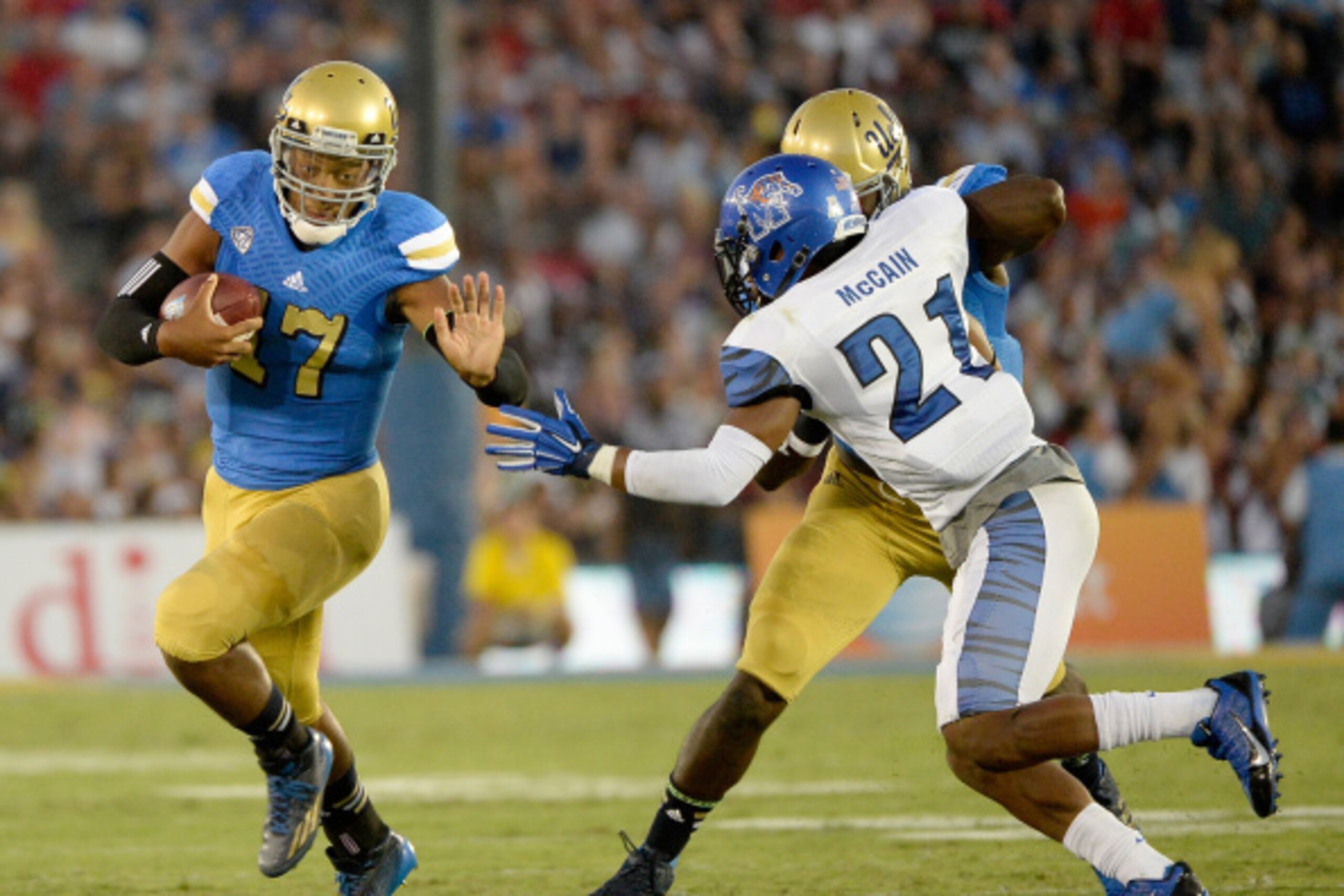 PASADENA, CA - SEPTEMBER 06:  Brett Hundley #17 of the UCLA Bruins scrambles out of the pocket as Bobby McCain #21 of the Memphis Tigers chases during the first half at Rose Bowl on September 6, 2014 in Pasadena, California.  (Photo by Harry How/Getty Ima