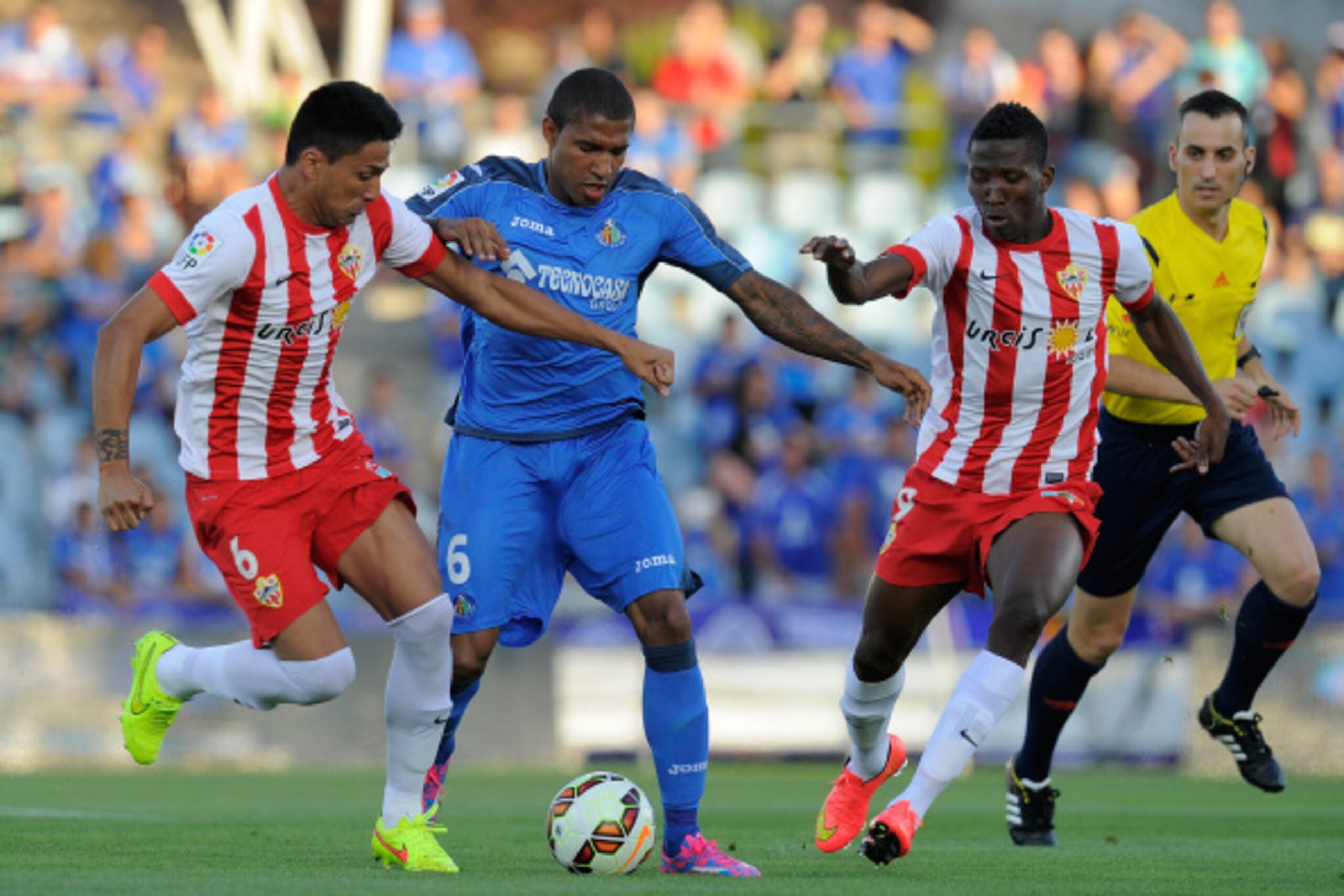 GETAFE, SPAIN - AUGUST 29: Jorge Sammir (C) of Getafe CF is tackled by Mauro Do Santos of UD Almeria during the La Liga match between Getafe CF and UD Almeria at Coliseum Alfonso Perez on August 29, 2014 in Getafe, Spain.  (Photo by Denis Doyle/Getty Imag