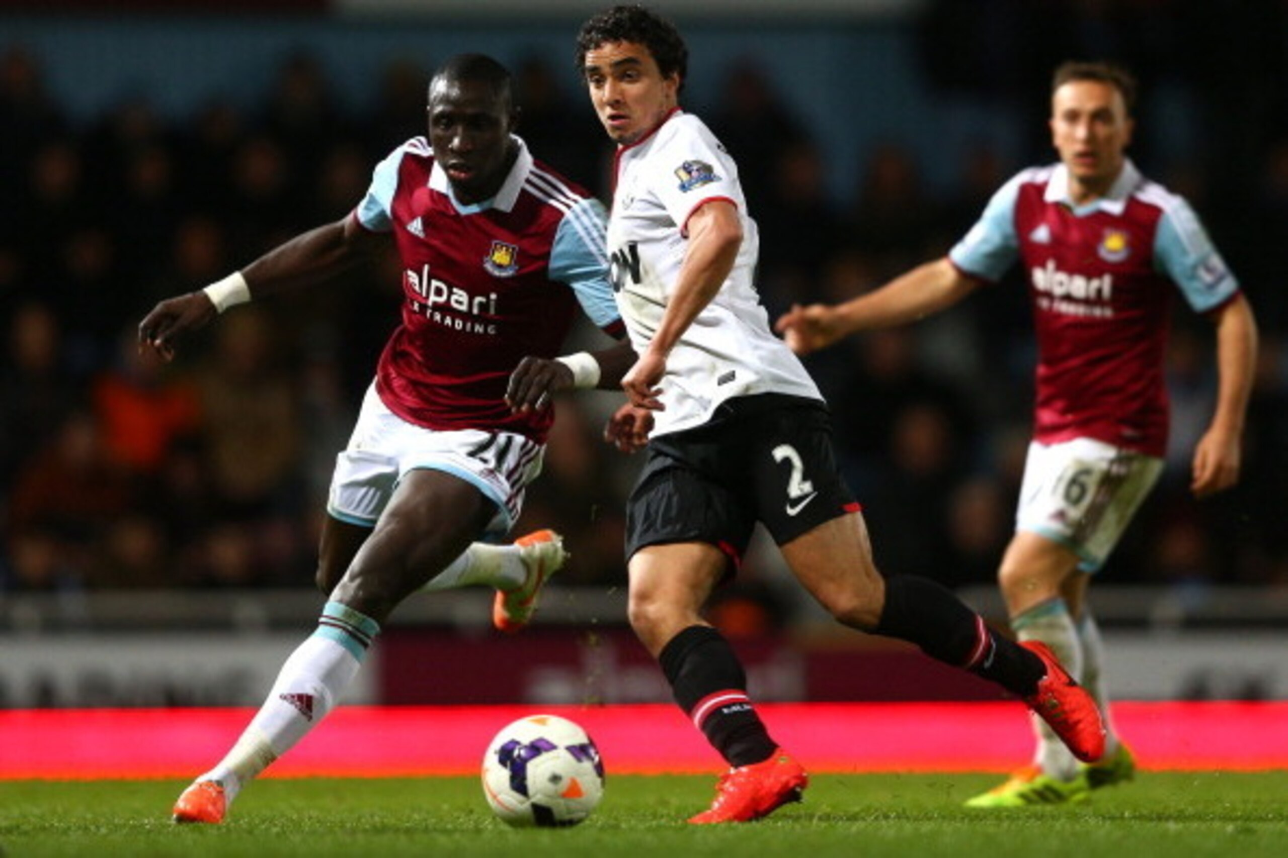 LONDON, ENGLAND - MARCH 22:  Rafael of Manchester United is closed down by Mohamed Diame of West Ham during the Barclays Premier League match between West Ham United and Manchester United at Boleyn Ground on March 22, 2014 in London, England.  (Photo by P