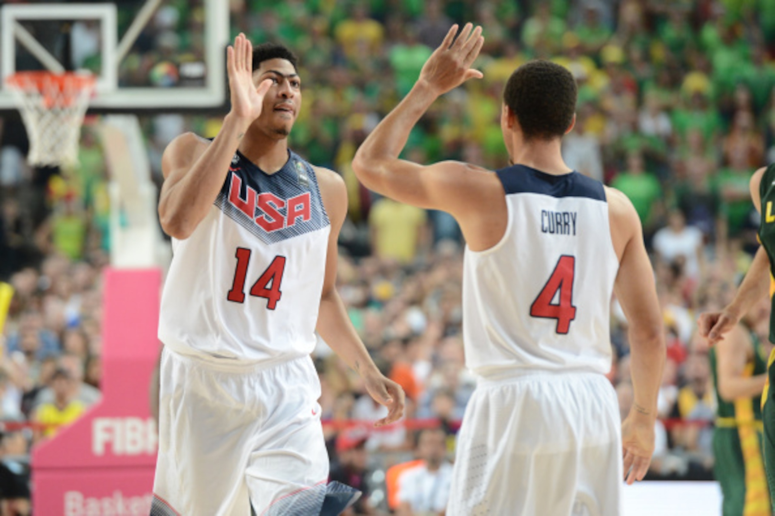 BARCELONA, SPAIN - SEPTEMBER 11: Anthony Davis #14 high fives Stephen Curry #4 of the USA Basketball Men's National Team in the game against the Lithuania National Team during the 2014 FIBA World Cup Semi-Finals at Palau Sant Jordi on September 11, 2014 i