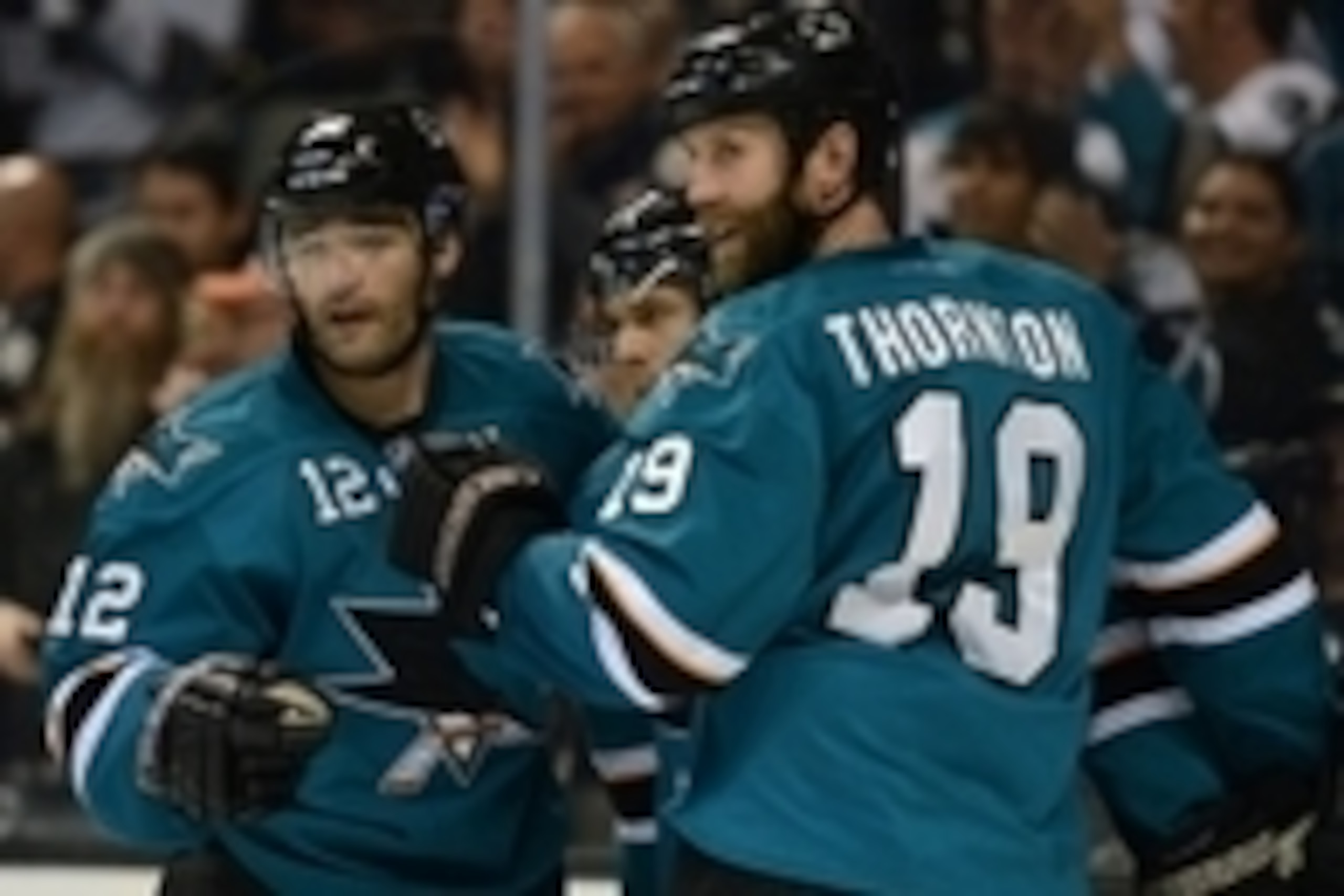 October 19, 2013; San Jose, CA, USA; San Jose Sharks center Patrick Marleau (12), center Joe Pavelski (8, center) and center Joe Thornton (19) celebrate after Pavelski scored a goal against the Calgary Flames during the second period at SAP Center at San 