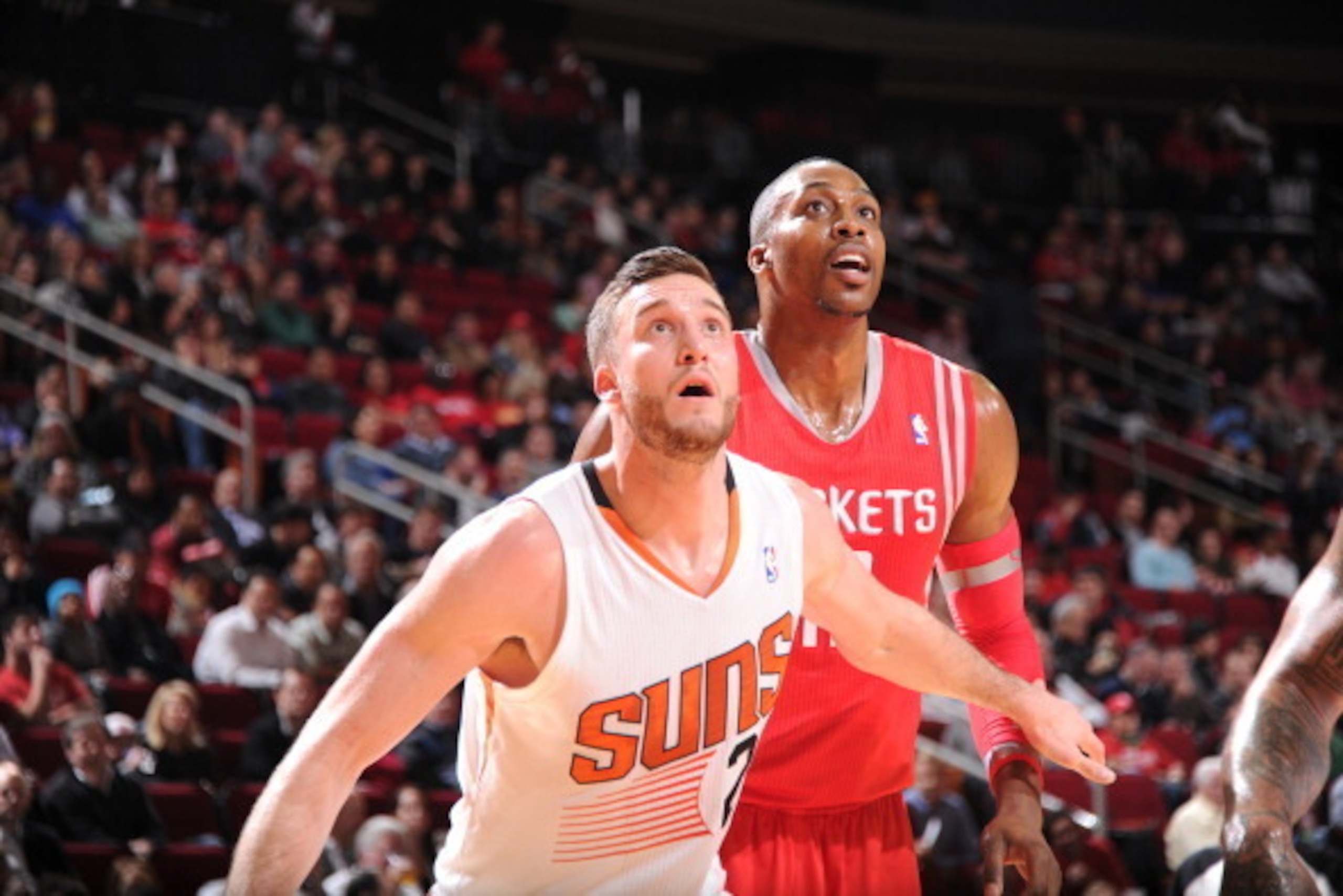HOUSTON, TX - FEBRUARY 5:  Dwight Howard #12 of the Houston Rockets and Miles Plumlee #22 of the Phoenix Suns battle for the rebound on February 5, 2014 at the Toyota Center in Houston, Texas. NOTE TO USER: User expressly acknowledges and agrees that, by 