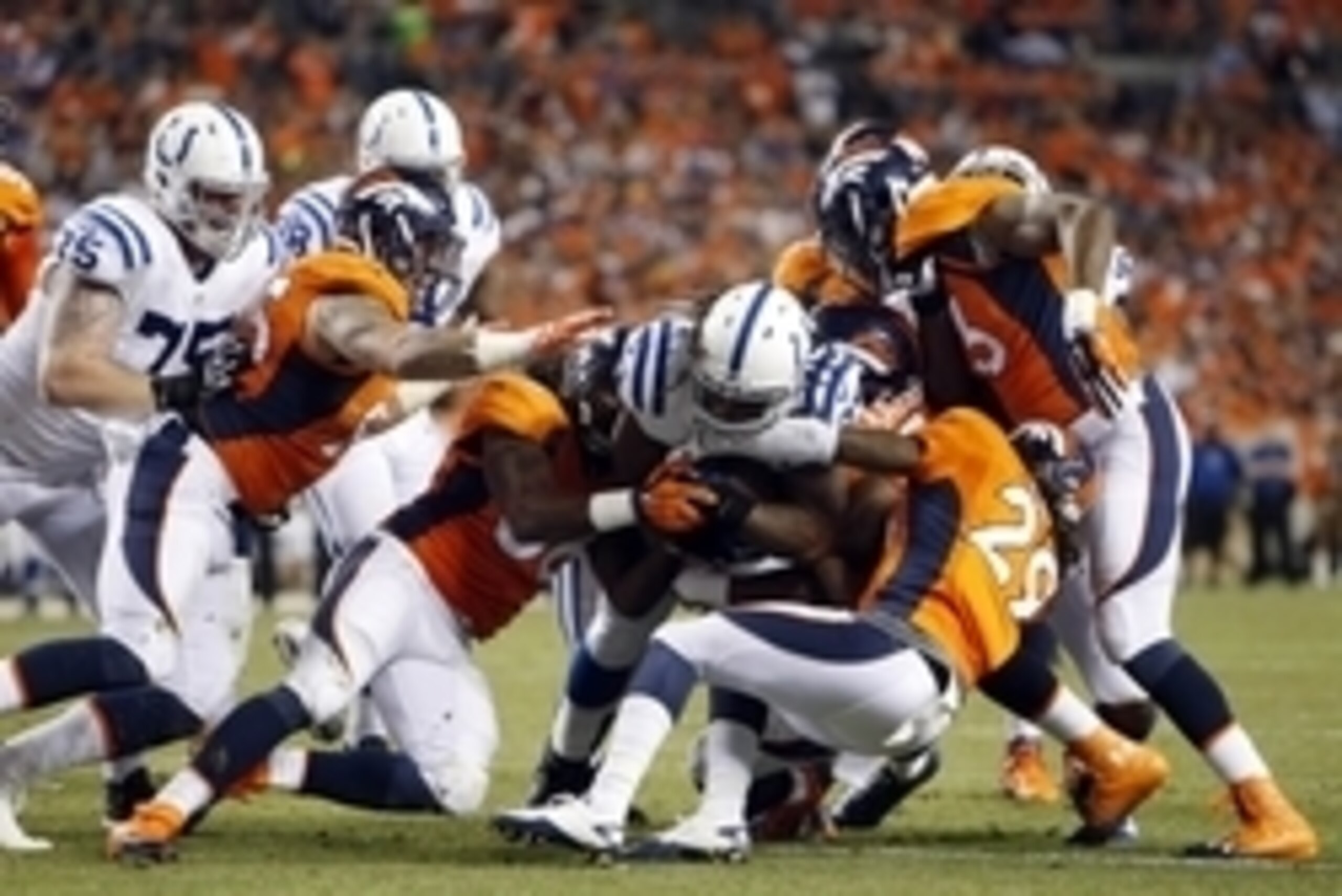Sep 7, 2014; Denver, CO, USA; Indianapolis Colts running back Trent Richardson (34) is tackled during the second half against the Denver Broncos at Sports Authority Field at Mile High. Mandatory Credit: Chris Humphreys-USA TODAY Sports