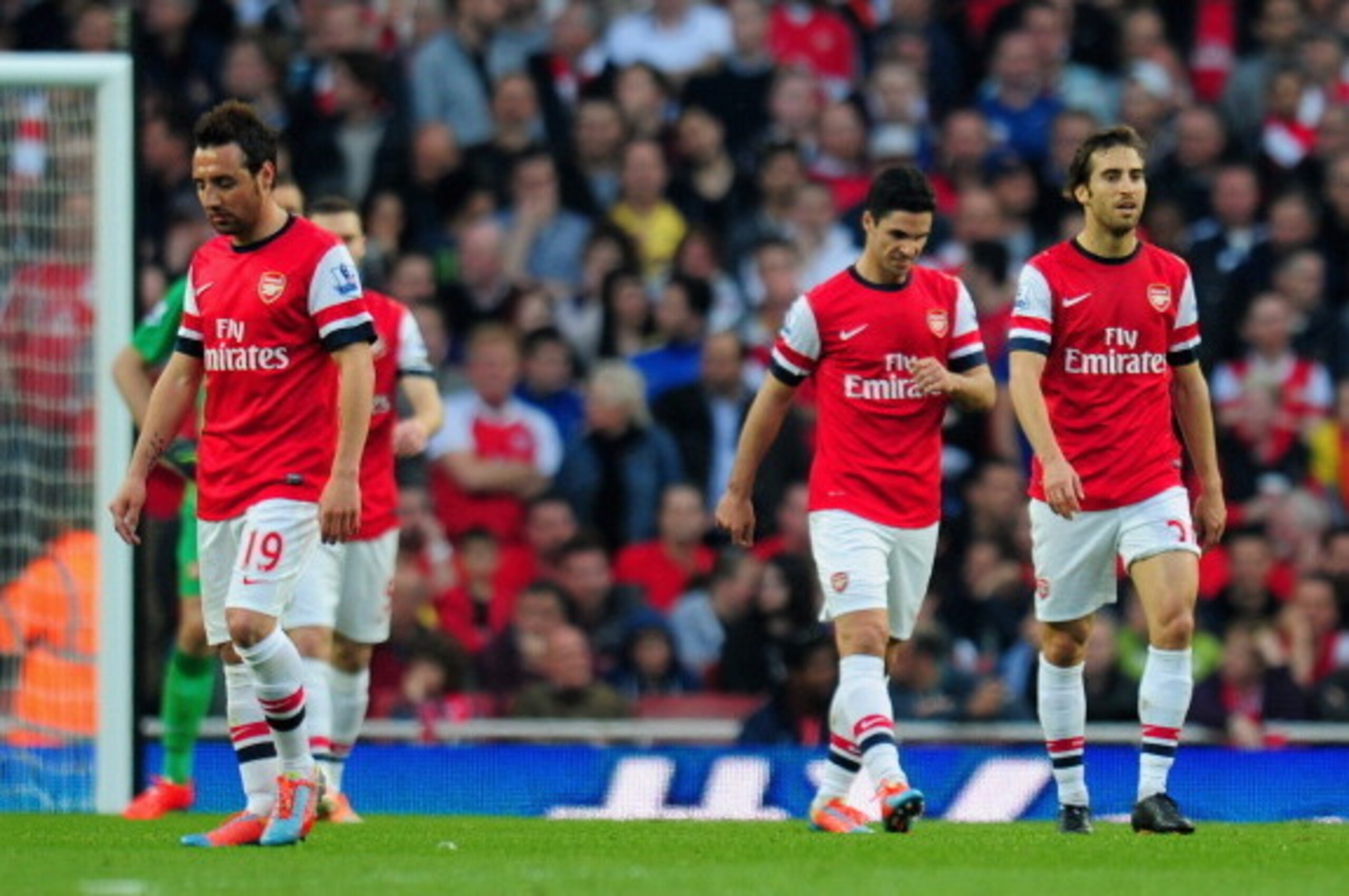 LONDON, ENGLAND - MARCH 29:  A dejected Santi Cazorla, Mikel Arteta and Mathieu Flamini of Arsenal after conceding the first goal during the Barclays Premier League match between Arsenal and Manchester City at Emirates Stadium on March 29, 2014 in London,
