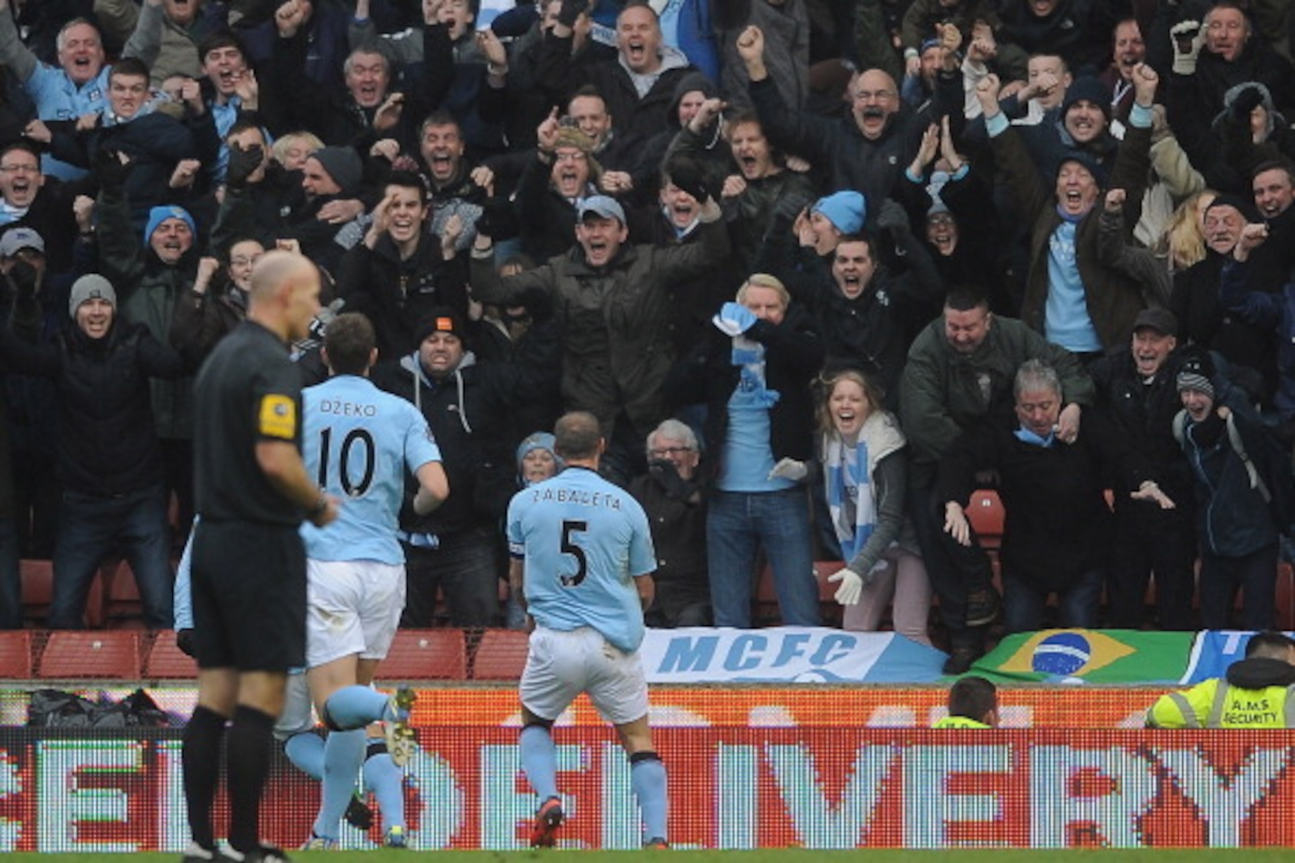 STOKE ON TRENT, ENGLAND - JANUARY 26: Man City fans celebrate their winning goal with Pablo Zabaleta of Man City during the FA Cup Fourth Round match between Stoke City and Manchester City at Britannia Stadium on January 26, 2013 in Stoke on Trent, Engla STOKE ON TRENT, ENGLAND - JANUARY 26: Man City fans celebrate their winning goal with Pablo Zabaleta of Man City during the FA Cup Fourth Round match between Stoke City and Manchester City at Britannia Stadium on January 26, 2013 in Stoke on Trent, Engla