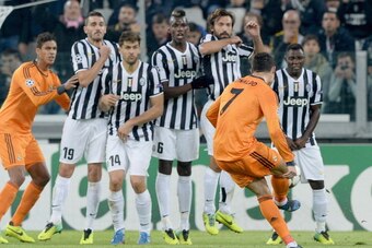 TURIN, ITALY - NOVEMBER 05:  Cristiano Ronaldo of Real Madrid tries to shoot a frre kick over the Juventus wall during the UEFA Champions League Group B match between Juventus and Real Madrid  at Juventus Arena on November 5, 2013 in Turin, Italy.  (Photo