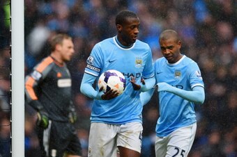 MANCHESTER, ENGLAND - MARCH 22:  Yaya Toure of Manchester City celebrates scoring their second goal with Fernandinho of Manchester City during the Barclays Premier League match between Manchester City and Fulham at Etihad Stadium on March 22, 2014 in Manc