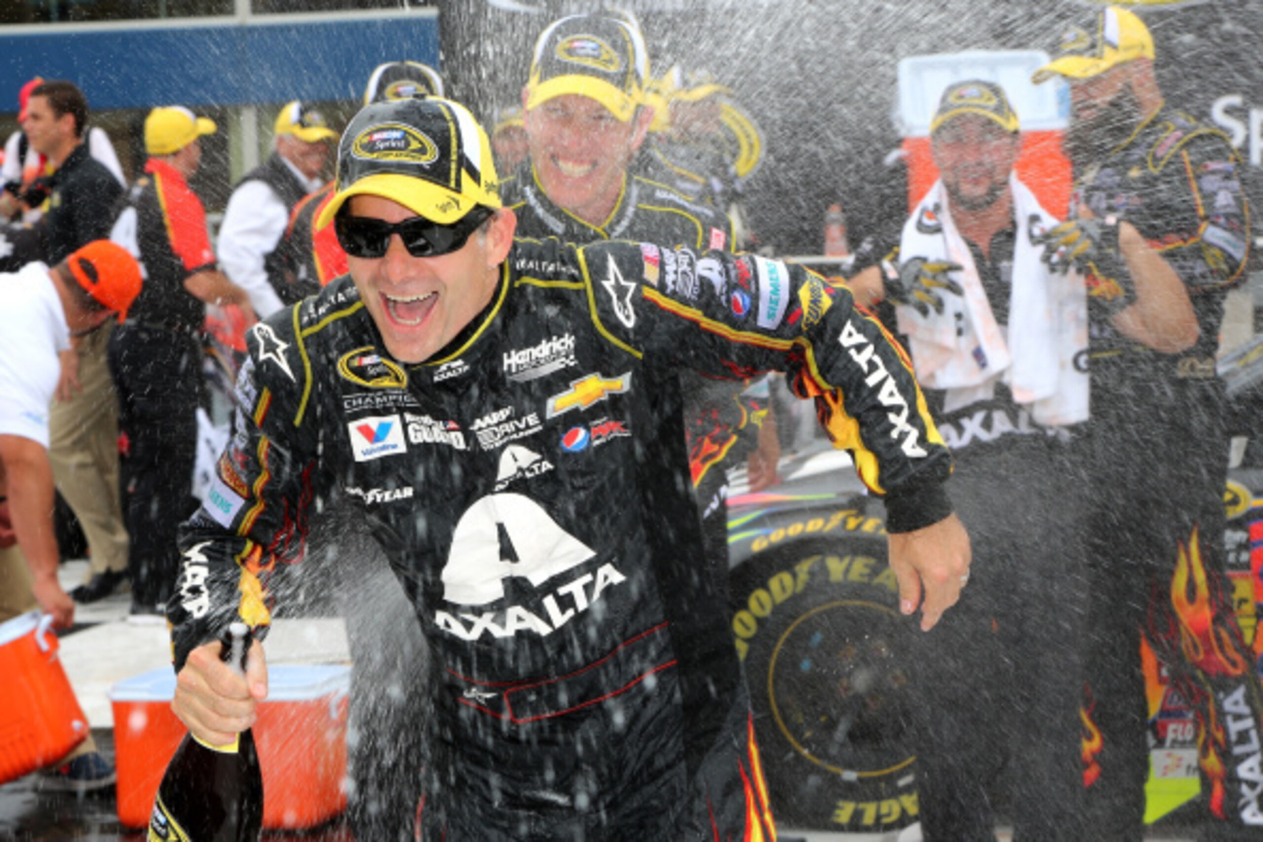 BROOKLYN, MI - AUGUST 17:  Jeff Gordon, driver of the #24 Axalta Chevrolet, is sprayed with champagne by his crew chief, Alan Gustafson, in victory lane after winning the NASCAR Sprint Cup Series Pure Michigan 400 at Michigan International Speedway on Aug