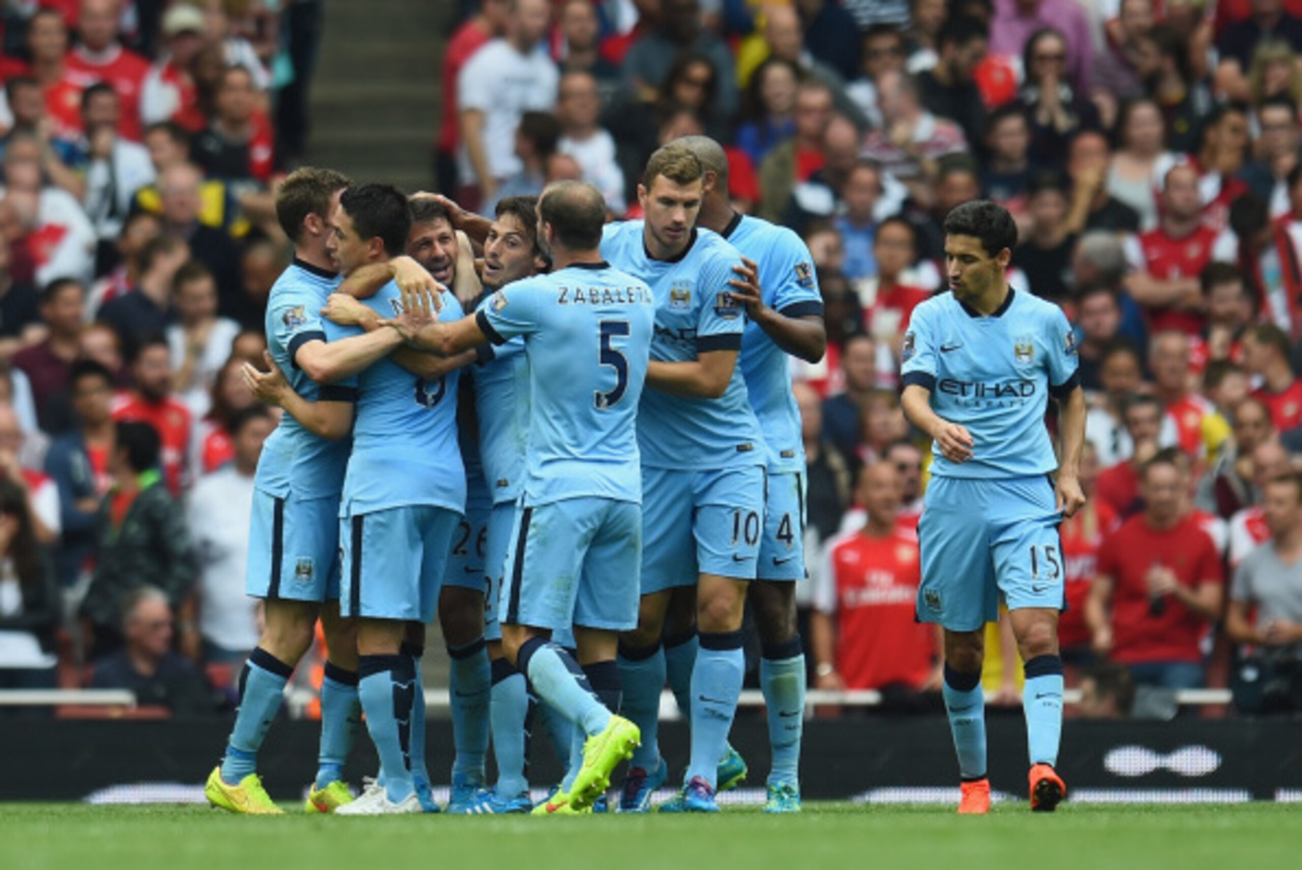 LONDON, ENGLAND - SEPTEMBER 13:  Martin Demichelis of Manchester City is congratulated by team-mates after scoring during the Barclays Premier League match between Arsenal and Manchester City at Emirates Stadium on September 13, 2014 in London, England.  