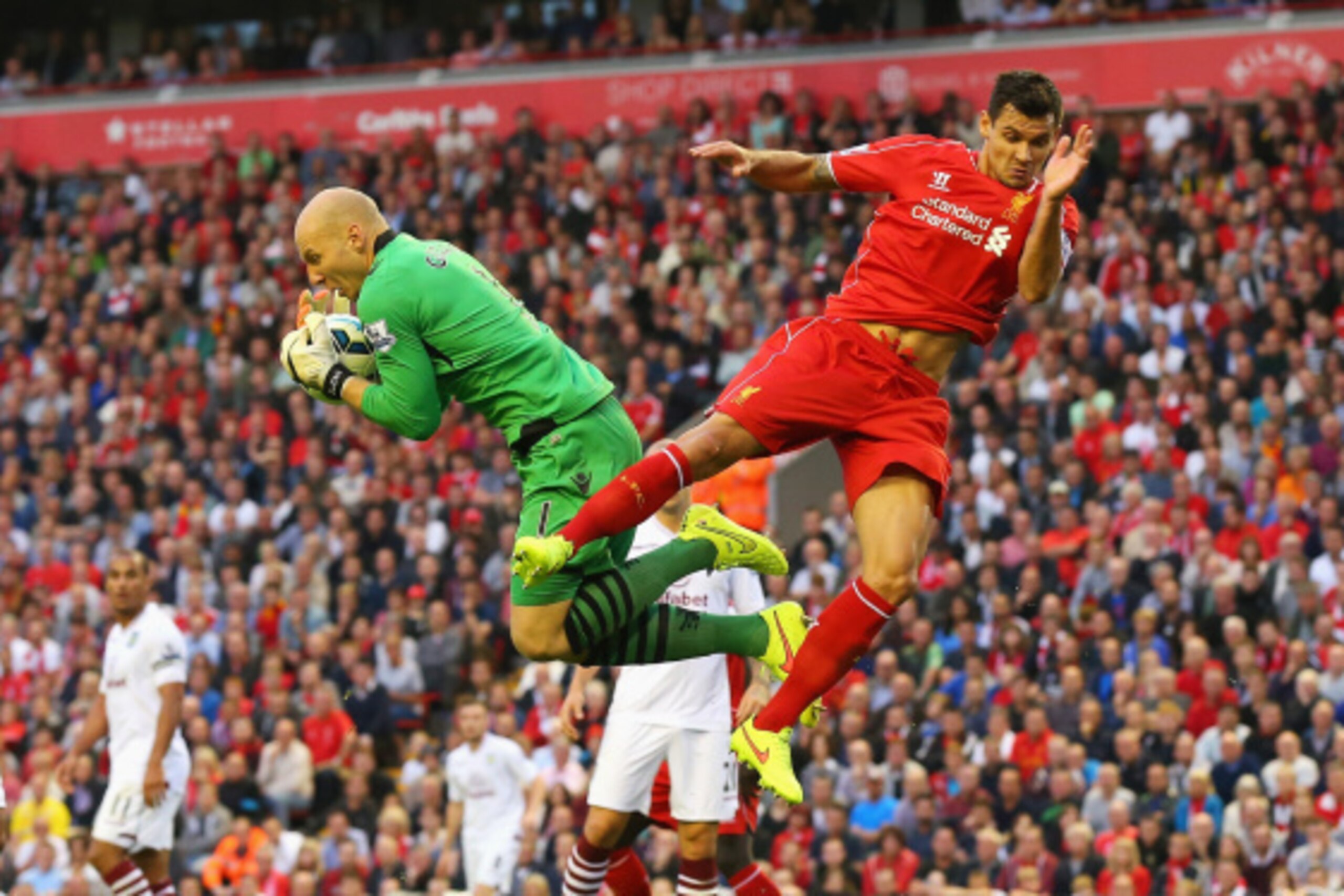 LIVERPOOL, ENGLAND - SEPTEMBER 13: Brad Guzan of Aston Villa claims the ball from Dejan Lovren of Liverpool during the Barclays Premier League match between Liverpool and Aston Villa at Anfield on September 13, 2014 in Liverpool, England.  (Photo by Alex 