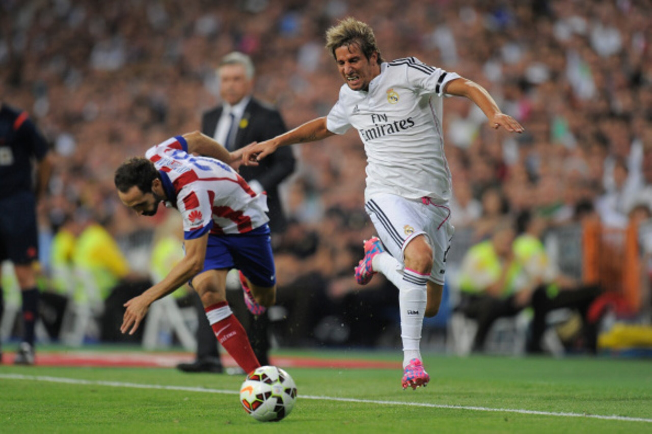 MADRID, SPAIN - SEPTEMBER 13: Fabio Coentrao of Real Madrid beats Juanfran of Atletico de Madrid during the La Liga match between Real Madrid and Atletico de Madrid at Estadio Santiago Bernabeu on September 13, 2014 in Madrid, Spain. (Photo by Denis Doy MADRID, SPAIN - SEPTEMBER 13: Fabio Coentrao of Real Madrid beats Juanfran of Atletico de Madrid during the La Liga match between Real Madrid and Atletico de Madrid at Estadio Santiago Bernabeu on September 13, 2014 in Madrid, Spain. (Photo by Denis Doy