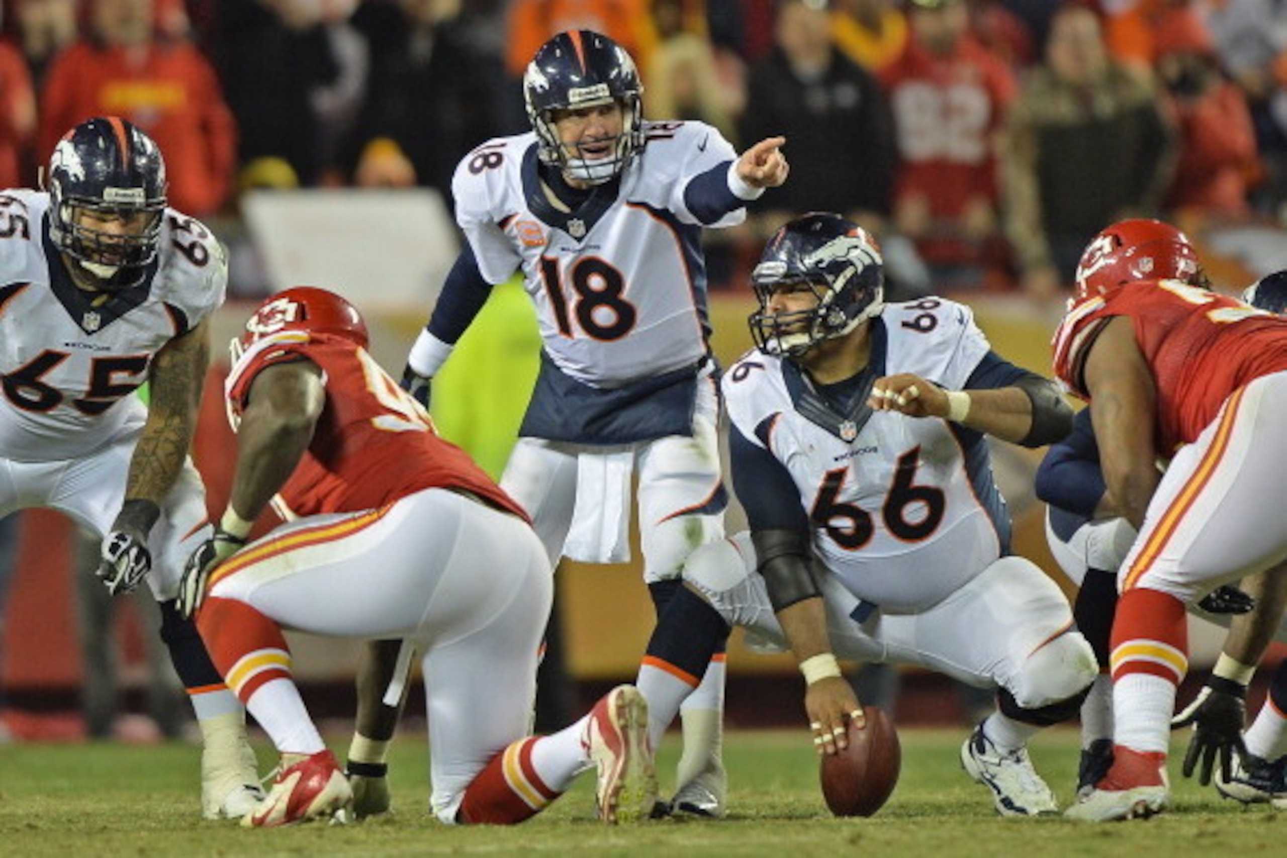 KANSAS CITY, MO - DECEMBER 01:  Quarterback Peyton Manning #18 of the Denver Broncos calls out some instructions to center Manny Ramirez #66 against the Kansas City Chiefs during the second half on December 1, 2013 at Arrowhead Stadium in Kansas City, Mis