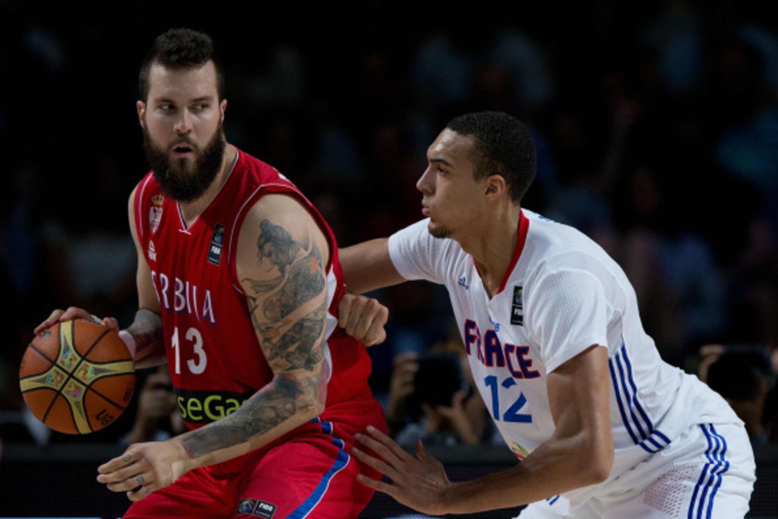 MADRID, SPAIN - SEPTEMBER 12: Miroslav Raduljica (L) of Serbia drives against Rudy Gobert (R) of France during the 2014 FIBA World Basketball Championship semifinal match between France and Serbia at Palacio de los Deportes on September 12, 2014 in Madrid
