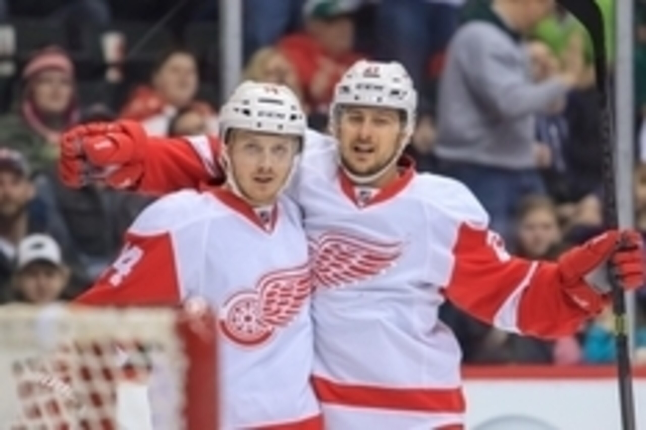 Mar 22, 2014; Saint Paul, MN, USA; Detroit Red Wings center Gustav Nyquist (14) celebrates his goal with left wing Tomas Tatar (21) in the third period against the Minnesota Wild at Xcel Energy Center. Detroit Red Wings wins 3-2. Mandatory Credit: Brad Re