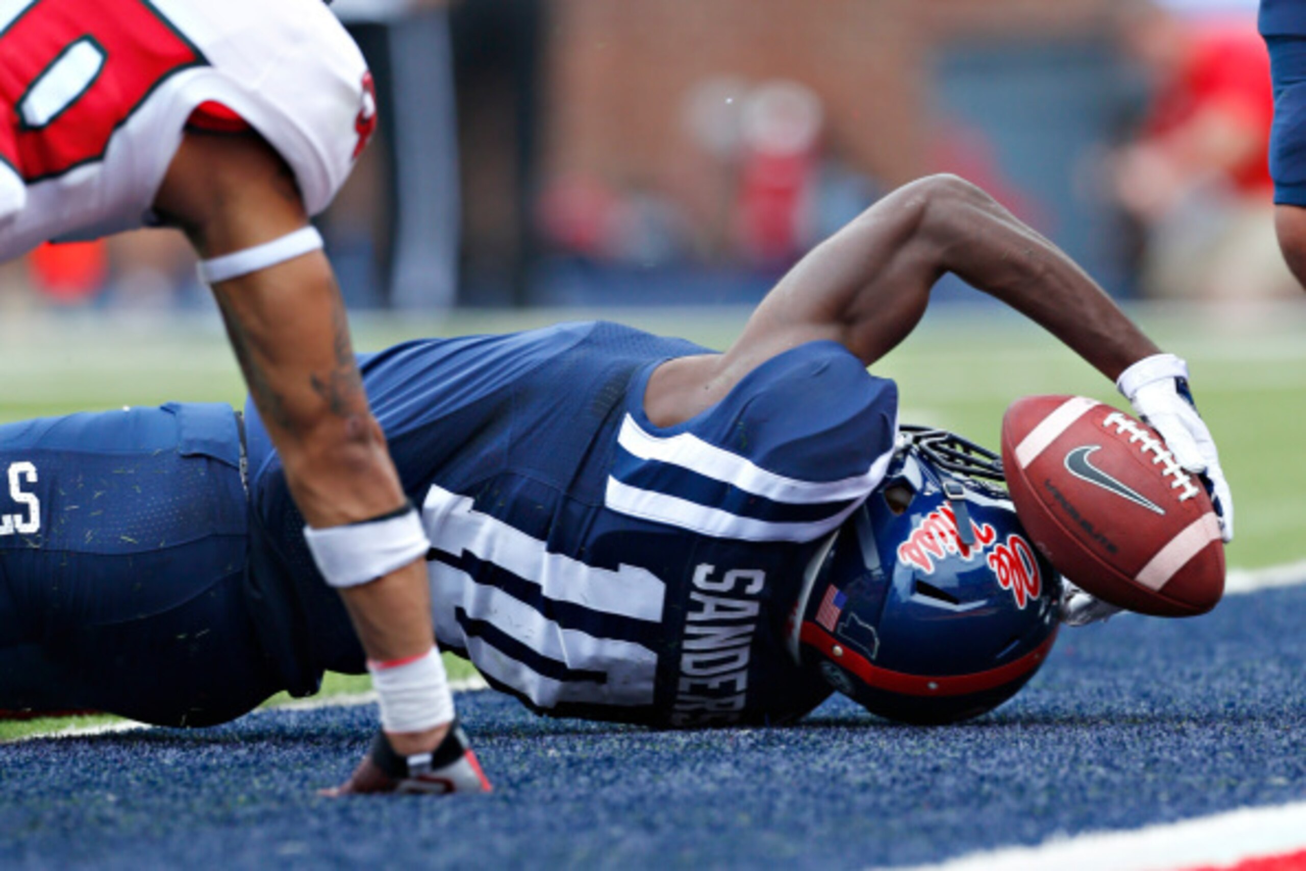 OXFORD, MS - SEPTEMBER 13:  Vince Sanders #10 of the Ole Miss Rebels holds onto the ball while crossing the end zone line for a touchdown against the Louisiana-Lafayette Ragin' Cajuns at Vaught-Hemingway Stadium on September 13, 2014 in Oxford, Mississipp