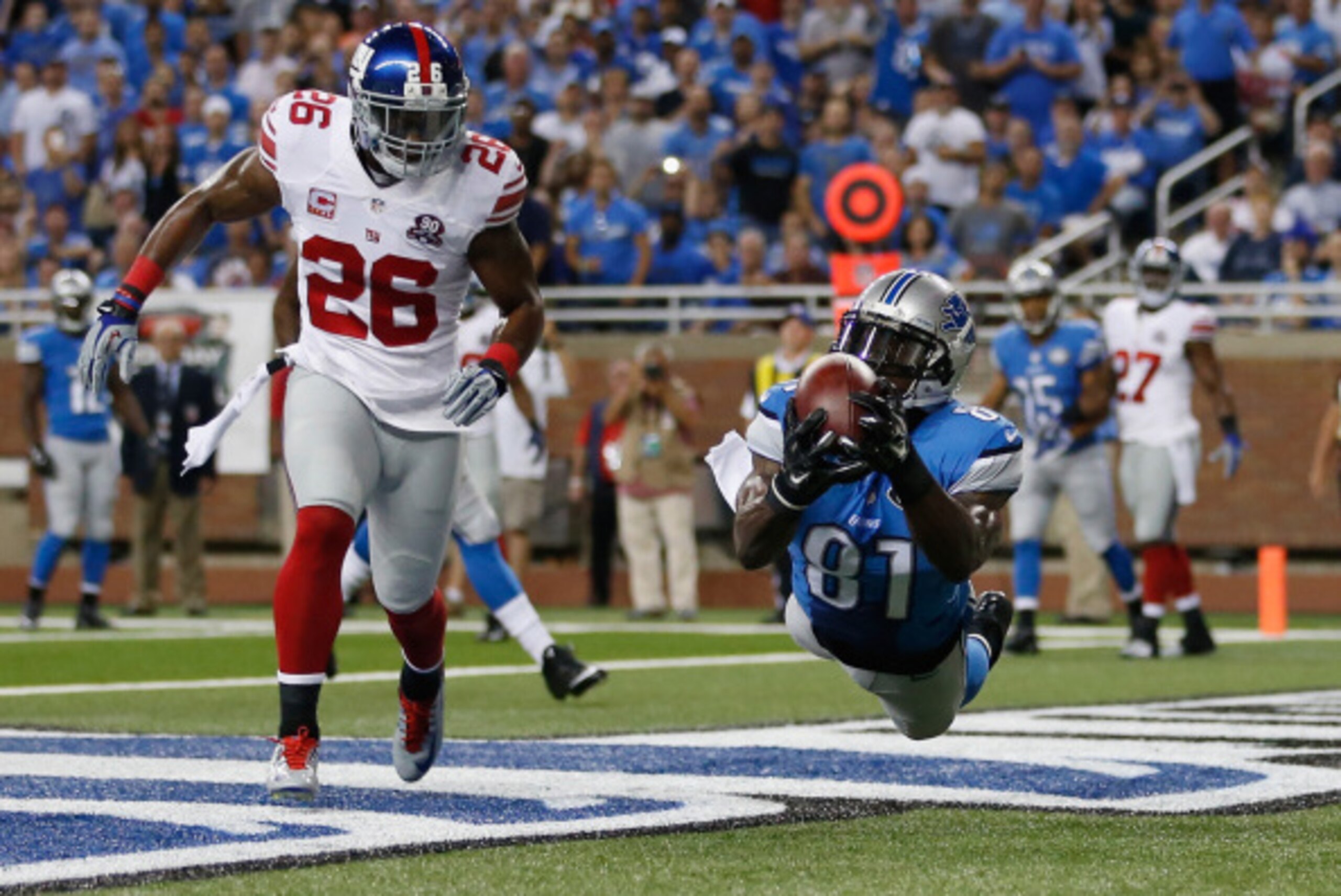 DETROIT, MI - SEPTEMBER 08: Calvin Johnson #81 of the Detroit Lions catches a first quarter touchdown next to Antrel Rolle #26 of the New York Giants at Ford Field on September 8, 2014 in Detroit, Michigan. (Photo by Gregory Shamus/Getty Images)