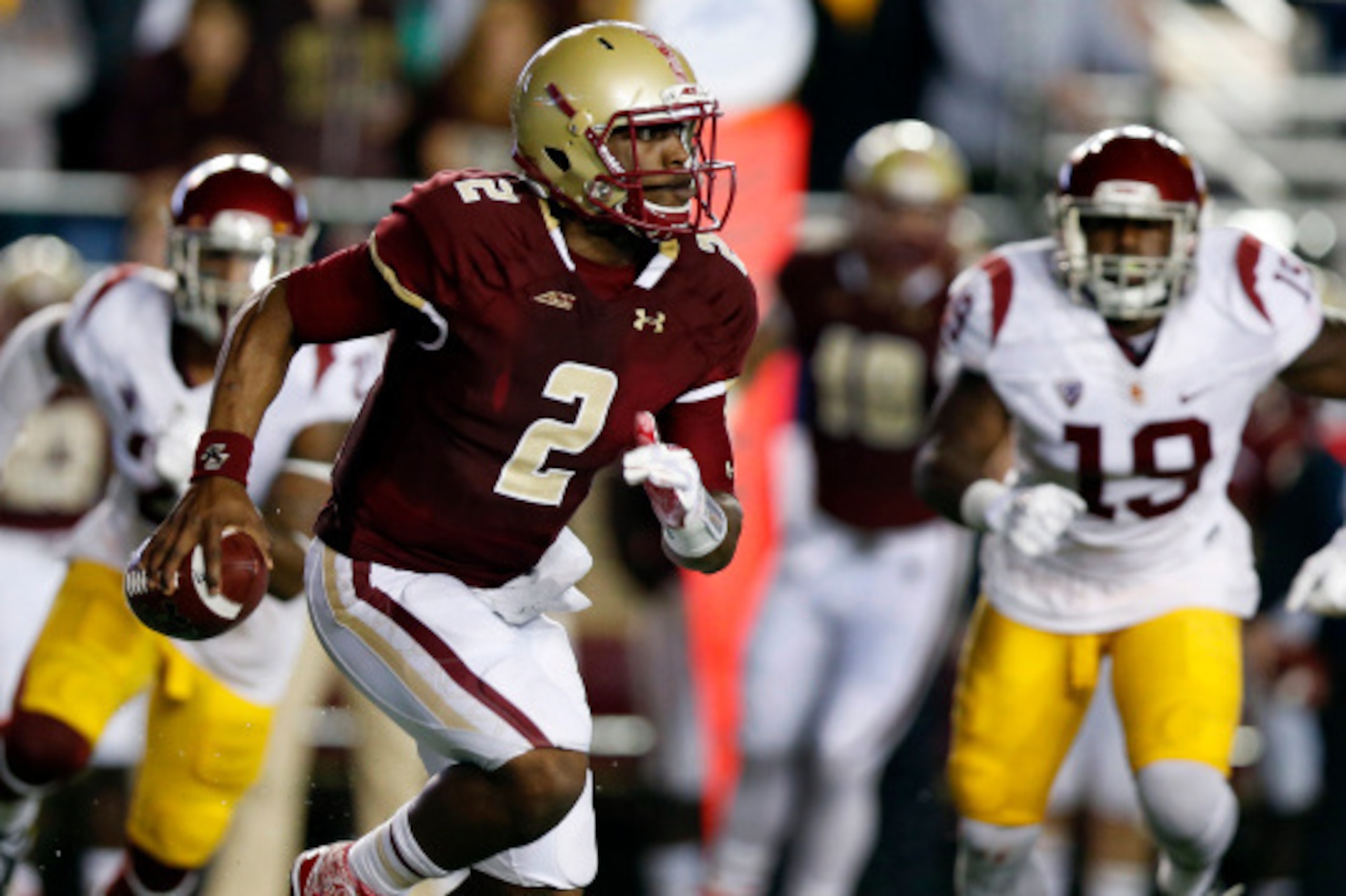 BOSTON, MA- SEPTEMBER 13: Quarterback Tyler Murphy #2 of the Boston College Eagle scrambles away from linebacker Michael Hutchings #19 of the USC Trojans during the first half at Alumni Stadium on September 13 in Chestnut Hill, Massachusetts.  (Photo by W