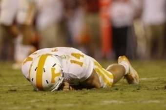 Sep 13, 2014; Norman, OK, USA; Tennessee Volunteers quarterback Justin Worley (14) lays on the ground after being hit during the game against the Oklahoma Sooners at Gaylord Family - Oklahoma Memorial Stadium. Mandatory Credit: Kevin Jairaj-USA TODAY Spor