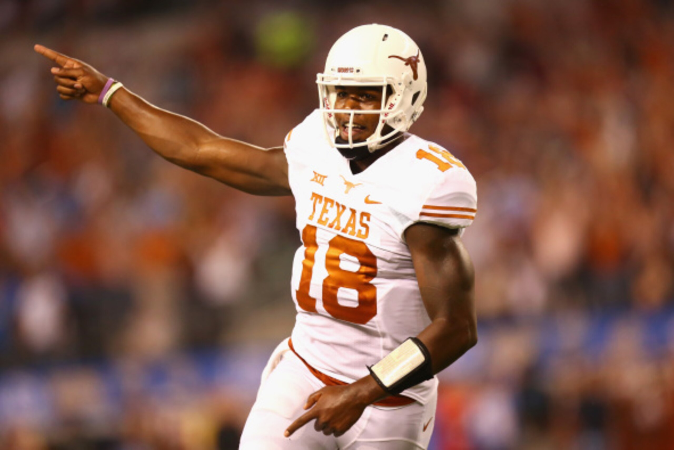 ARLINGTON, TX - SEPTEMBER 13:  Tyrone Swoopes #18 of the Texas Longhorns celebrates his touchdown pass against the UCLA Bruins in the second quarter at AT&T Stadium on September 13, 2014 in Arlington, Texas.  (Photo by Ronald Martinez/Getty Images)