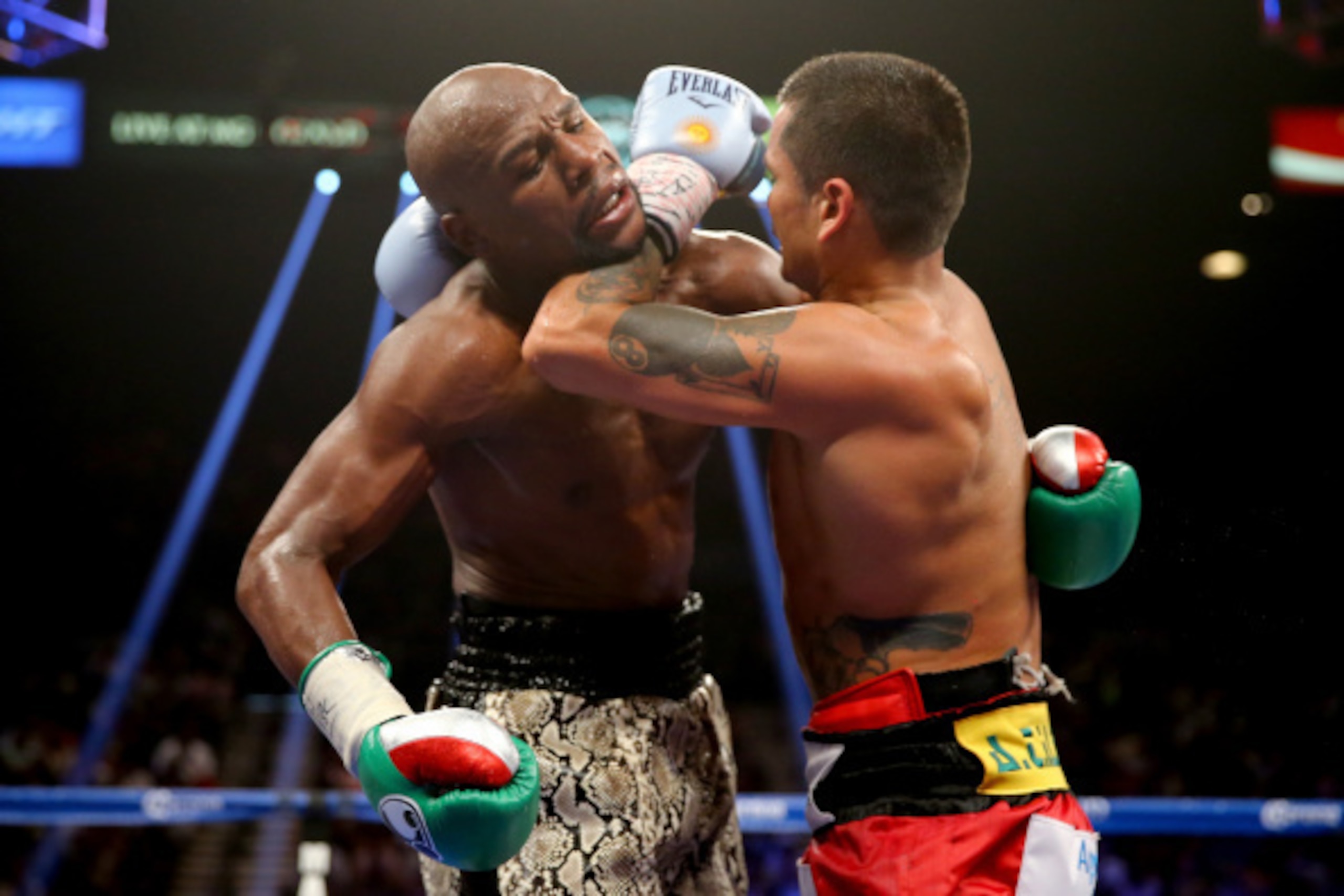LAS VEGAS, NV - SEPTEMBER 13:  (R-L) Marcos Maidana puts his left forearm in the neck of Floyd Mayweather Jr. during their WBC/WBA welterweight title fight at the MGM Grand Garden Arena on September 13, 2014 in Las Vegas, Nevada.  (Photo by Al Bello/Getty