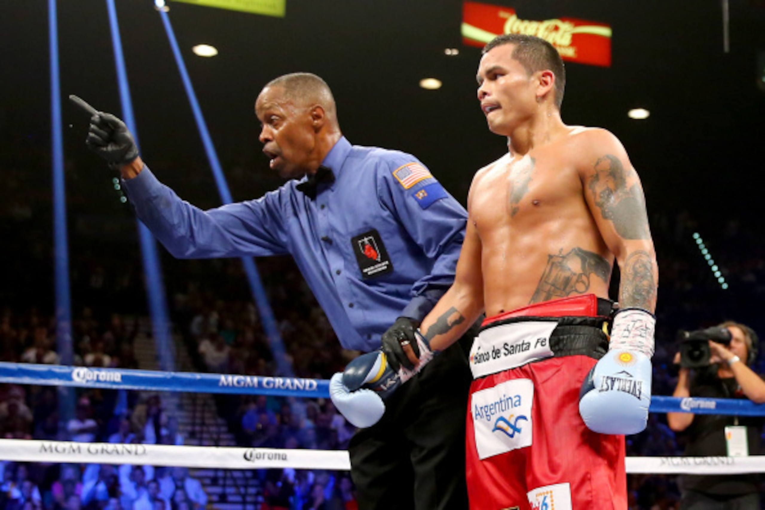 LAS VEGAS, NV - SEPTEMBER 13:  Referee Kenny Bayless deducts a point from Marcos Maidana for pushing down Floyd Mayweather Jr. during their WBC/WBA welterweight title fight at the MGM Grand Garden Arena on September 13, 2014 in Las Vegas, Nevada.  (Photo 