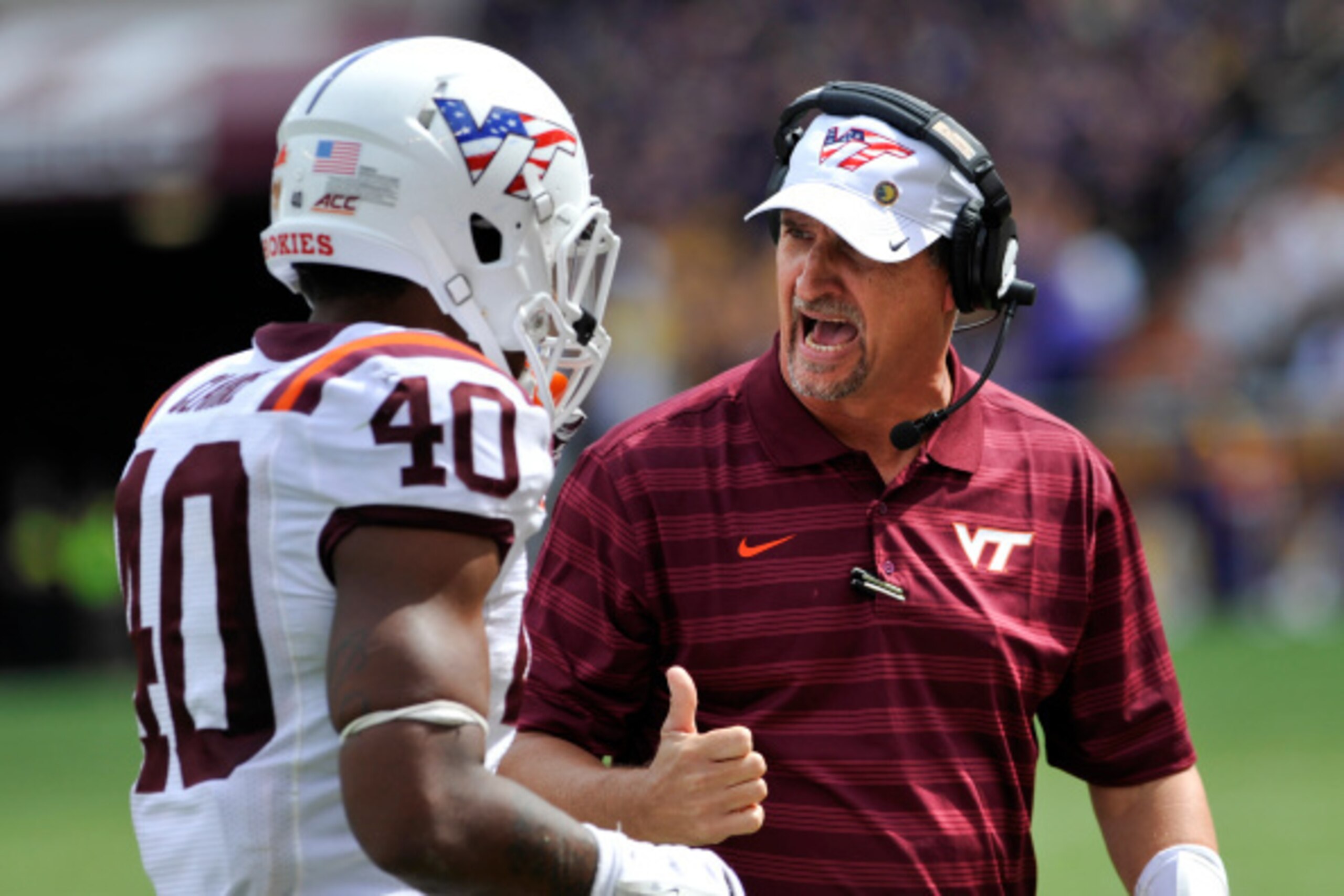 BLACKSBURG, VA - SEPTEMBER 13: Defensive coordinator Bud Foster of the Virginia Tech Hokies gives instructions to linebacker Deon Clarke #40 during a game against the East Carolina Pirates at Lane Stadium on September 13, 2014 in Blacksburg, Virginia. Eas