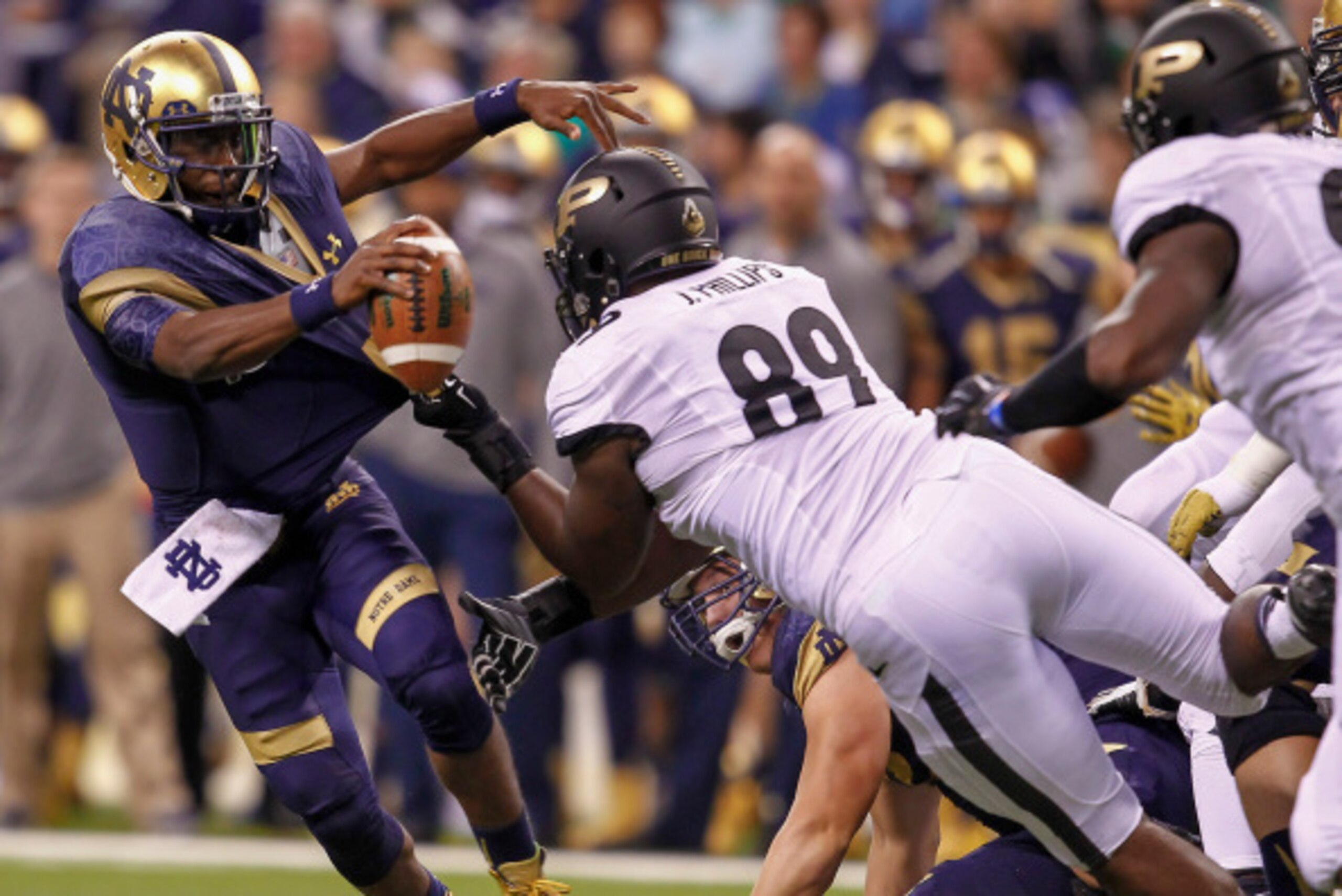 INDIANAPOLIS, IN - SEPTEMBER 13: Everett Golson #5 of the Notre Dame Fighting Irish tries to allude the sack of Jalani Phillips #89 of the Purdue Boilermakers at Lucas Oil Stadium on September 13, 2014 in Indianapolis, Indiana.  (Photo by Michael Hickey/G
