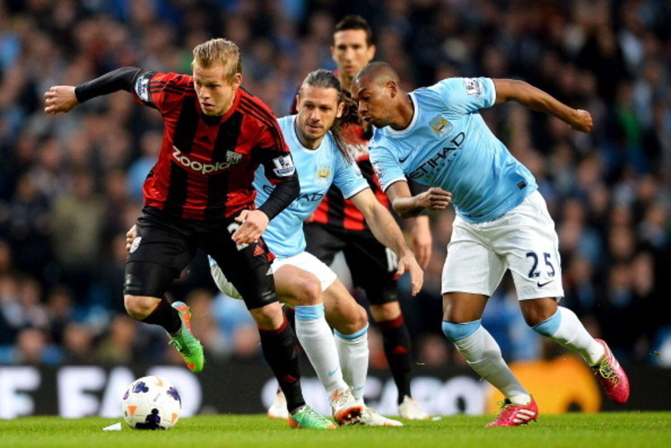 MANCHESTER, ENGLAND - APRIL 21:  Matej Vydra of West Bromwich Albion (L) evades Martin Demichelis (C) and Fernandinho of Manchester City (R) during the Barclays Premier League match between Manchester City and West Bromwich Albion at Etihad Stadium on Apr