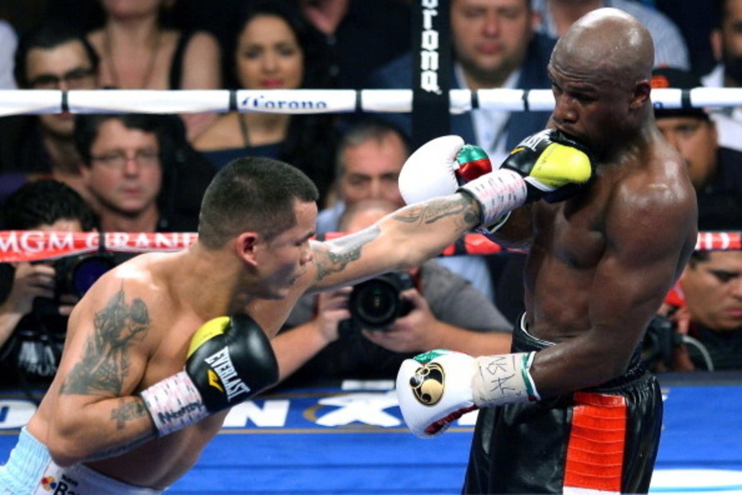 LAS VEGAS, NV - MAY 03:  Marcos Maidana (L) throws a left at Floyd Mayweather Jr. in the eighth round of their WBC/WBA welterweight unification fight at the MGM Grand Garden Arena on May 3, 2014 in Las Vegas, Nevada. Mayweather took Maidana's title with a