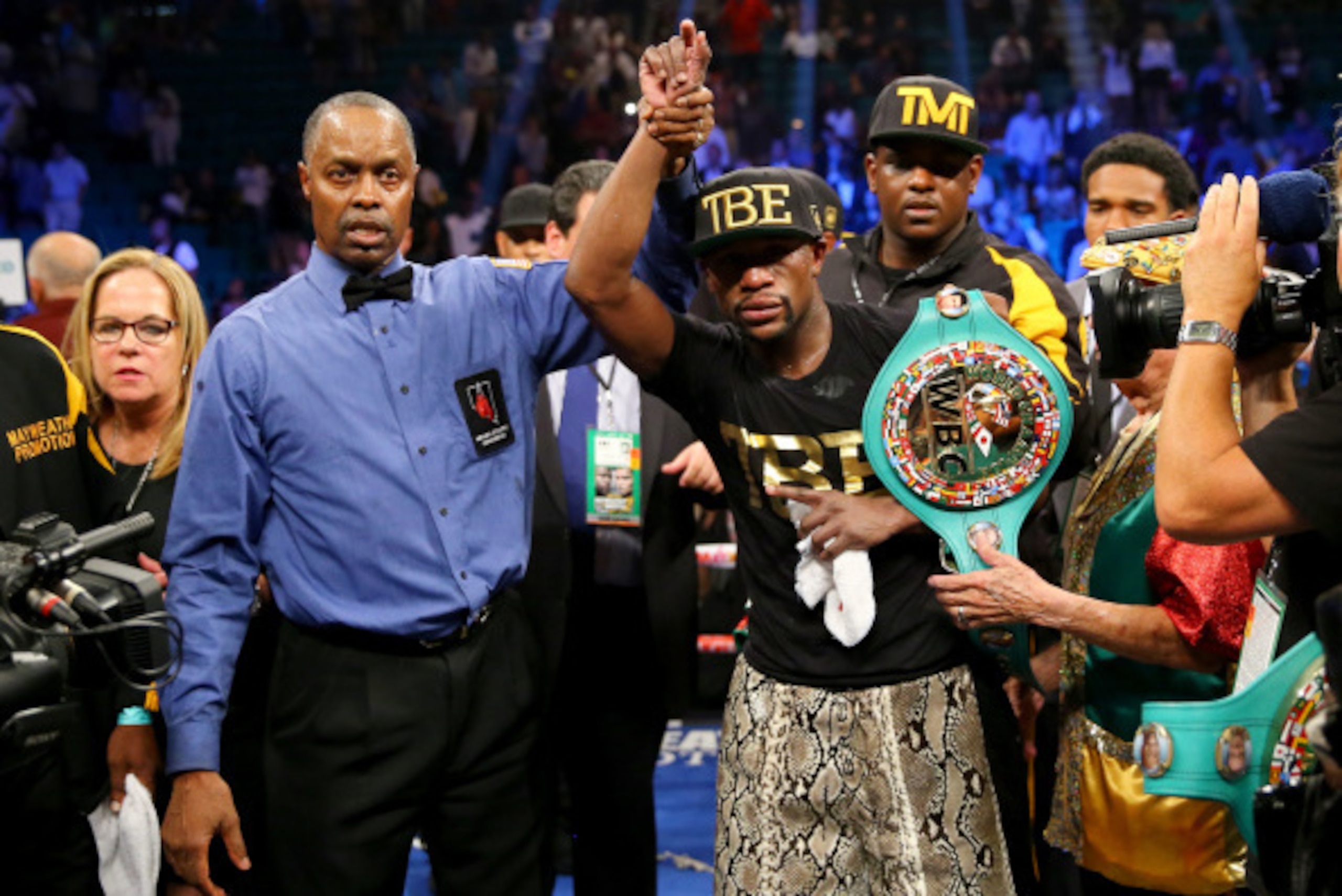 LAS VEGAS, NV - SEPTEMBER 13:  Referee Kenny Bayless (L) holds up Floyd Mayweather Jr.'s hand as he celebrates his unanimous-decision victory over Marcos Maidana during their WBC/WBA welterweight title fight at the MGM Grand Garden Arena on September 13, 