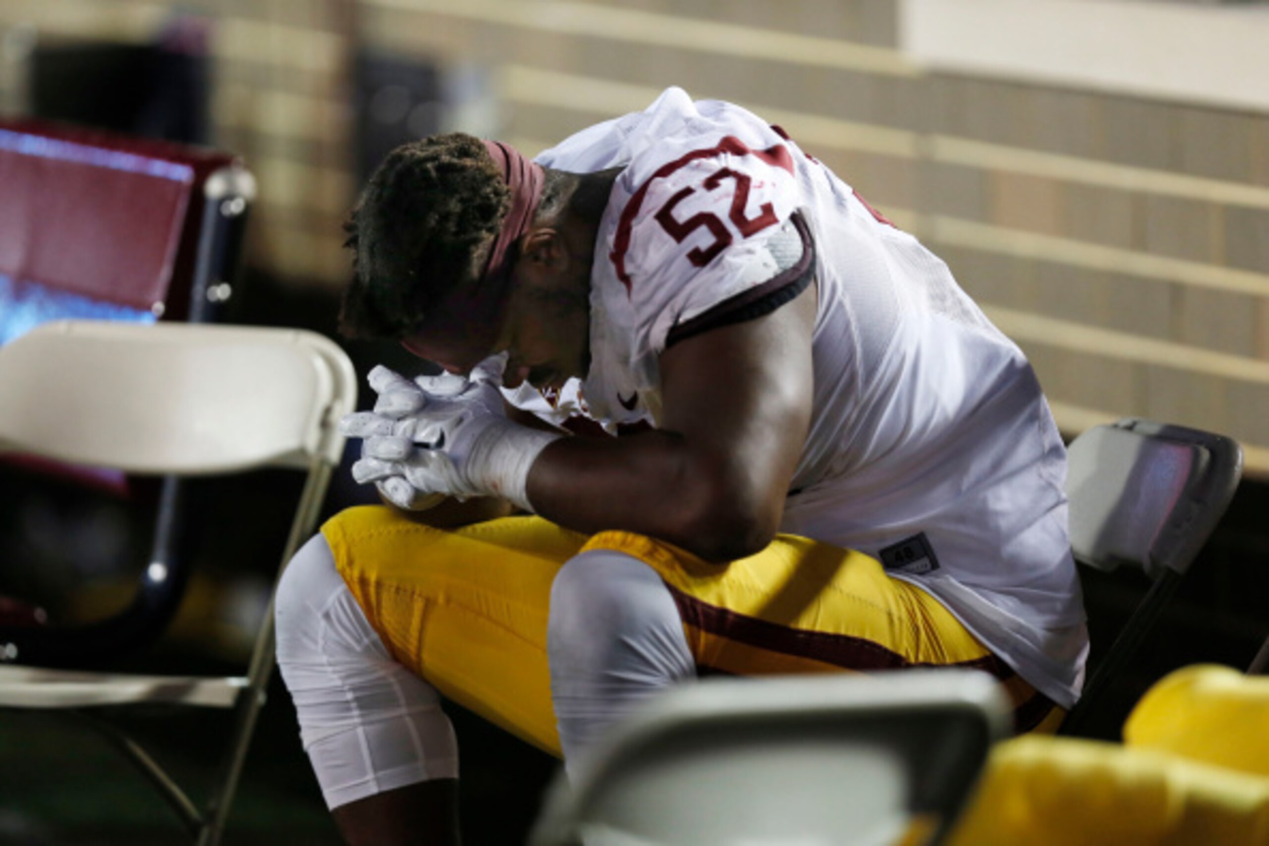 BOSTON, MA- SEPTEMBER 13:  Defensive tackle Delvon Simmons #52 of the USC Trojans sits alone on the bench during the final minutes of their 37-31 loss to the Boston College Eagles at Alumni Stadium on September 13 in Chestnut Hill, Massachusetts.  (Photo 