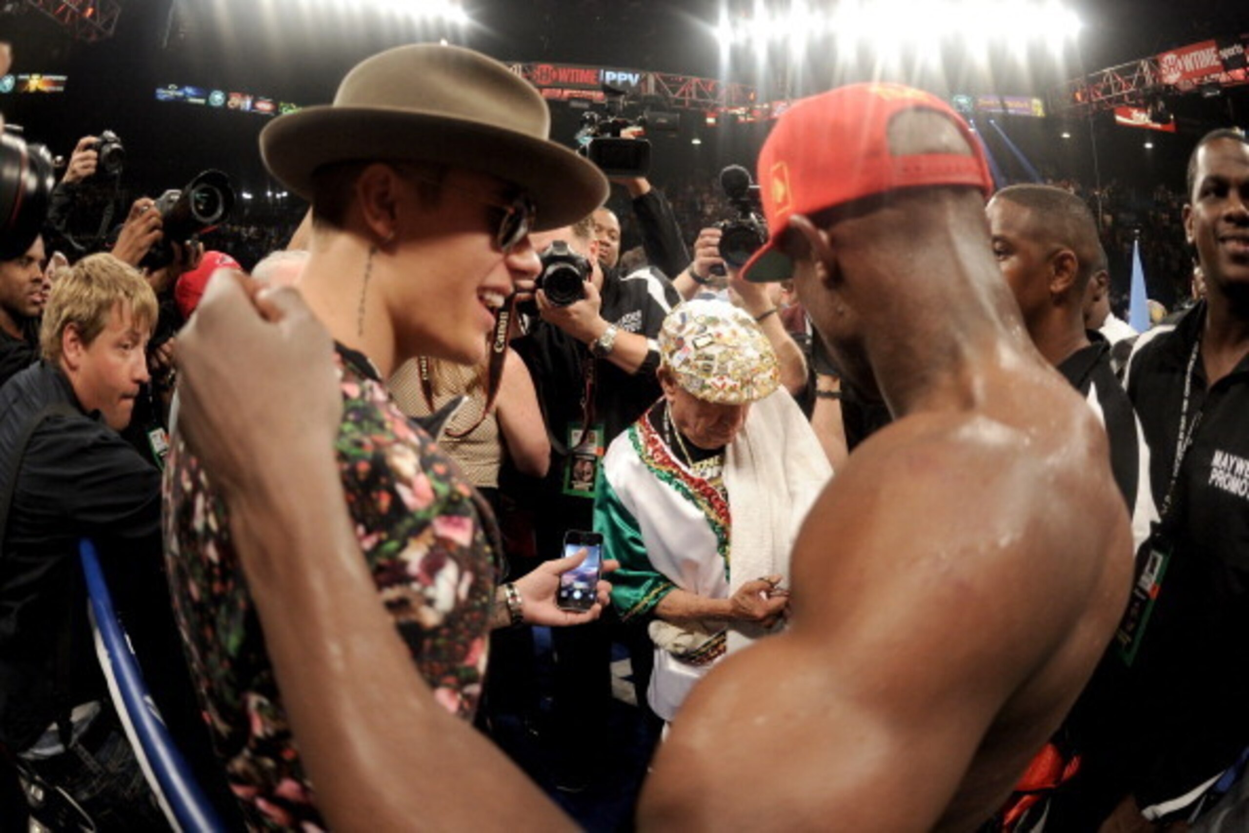 LAS VEGAS, NV - MAY 03: Singer Justin Bieber and Floyd Mayweather Jr. celebrate after Mayweather Jr. defeated Marcos Maidana by majority decision in their WBC/WBA welterweight unification fight at the MGM Grand Garden Arena on May 3, 2014 in Las Vegas, N LAS VEGAS, NV - MAY 03: Singer Justin Bieber and Floyd Mayweather Jr. celebrate after Mayweather Jr. defeated Marcos Maidana by majority decision in their WBC/WBA welterweight unification fight at the MGM Grand Garden Arena on May 3, 2014 in Las Vegas, N