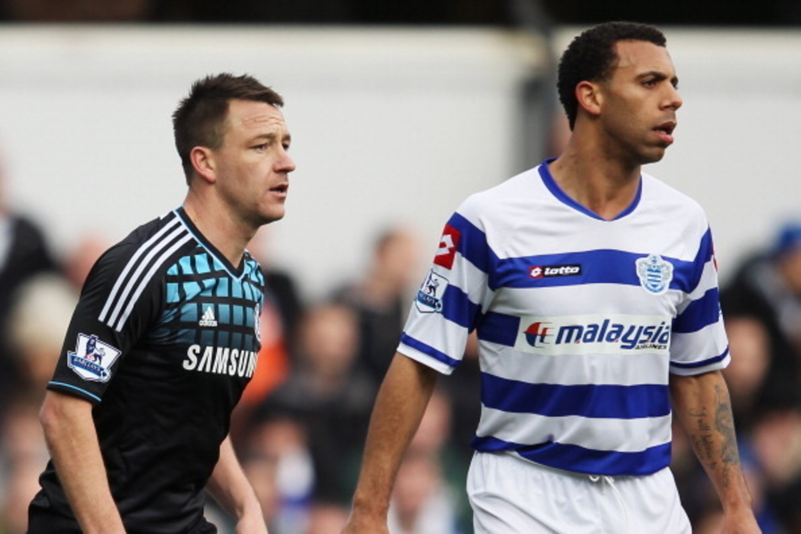 LONDON, ENGLAND - JANUARY 28:  John Terry of Chelsea prepares to defend a corner with Anton Ferdinand of Queens Park Rangers during the FA Cup with Budweiser Fourth Round match between Queens Park Rangers and Chelsea at Loftus Road on January 28, 2012 in 