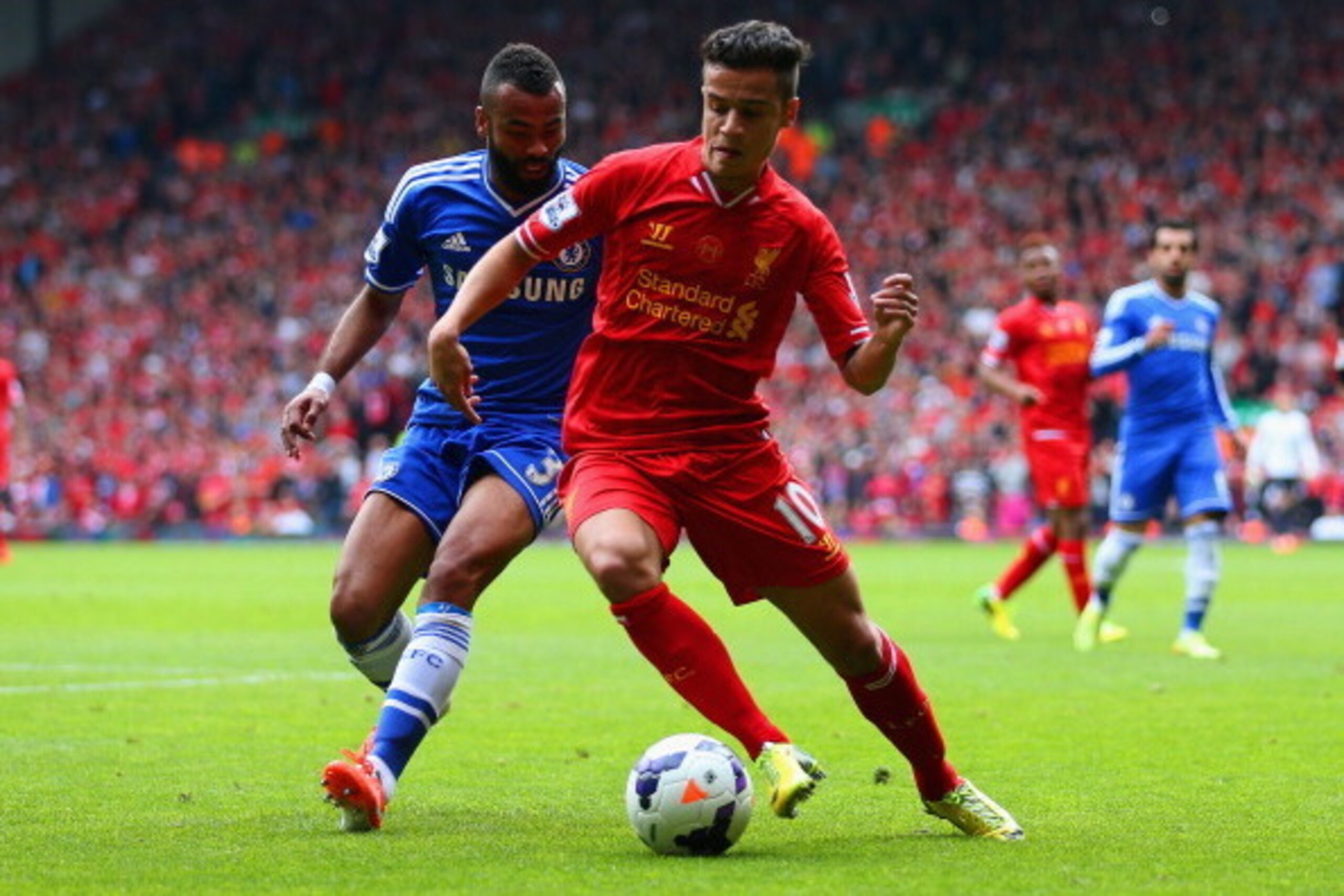 LIVERPOOL, ENGLAND - APRIL 27: Ashley Cole of Chelsea and Philippe Coutinho of Liverpool compete for the ball during the Barclays Premier League match between Liverpool and Chelsea at Anfield on April 27, 2014 in Liverpool, England.  (Photo by Clive Bruns