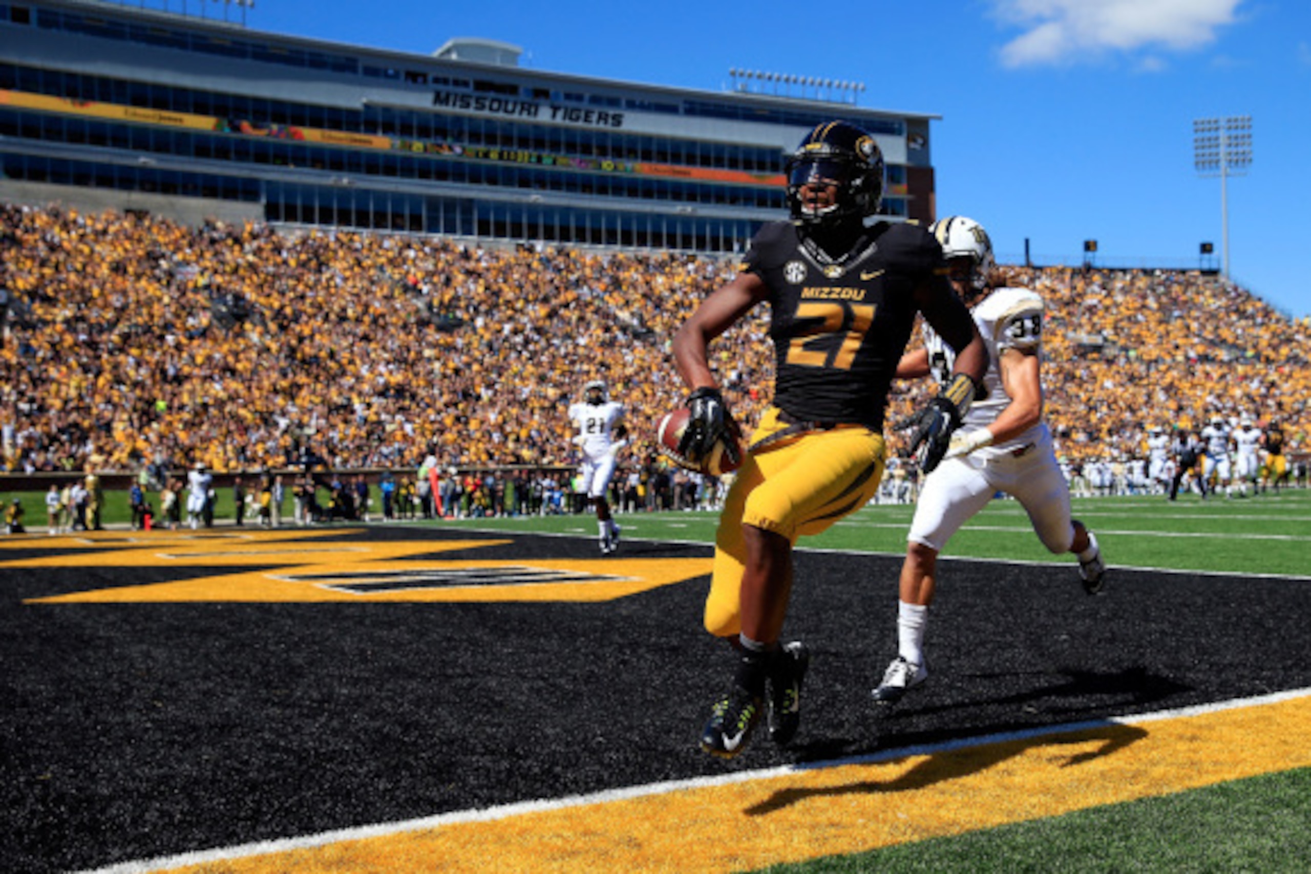 COLUMBIA, MO - SEPTEMBER 13: Wide receiver Bud Sasser #21 of the Missouri Tigers makes a catch in the end zone for a touchdown as defensive back Jordan Ozerities #38 of the UCF Knights defends during the second half of the game on September 13, 2014 at F COLUMBIA, MO - SEPTEMBER 13: Wide receiver Bud Sasser #21 of the Missouri Tigers makes a catch in the end zone for a touchdown as defensive back Jordan Ozerities #38 of the UCF Knights defends during the second half of the game on September 13, 2014 at F