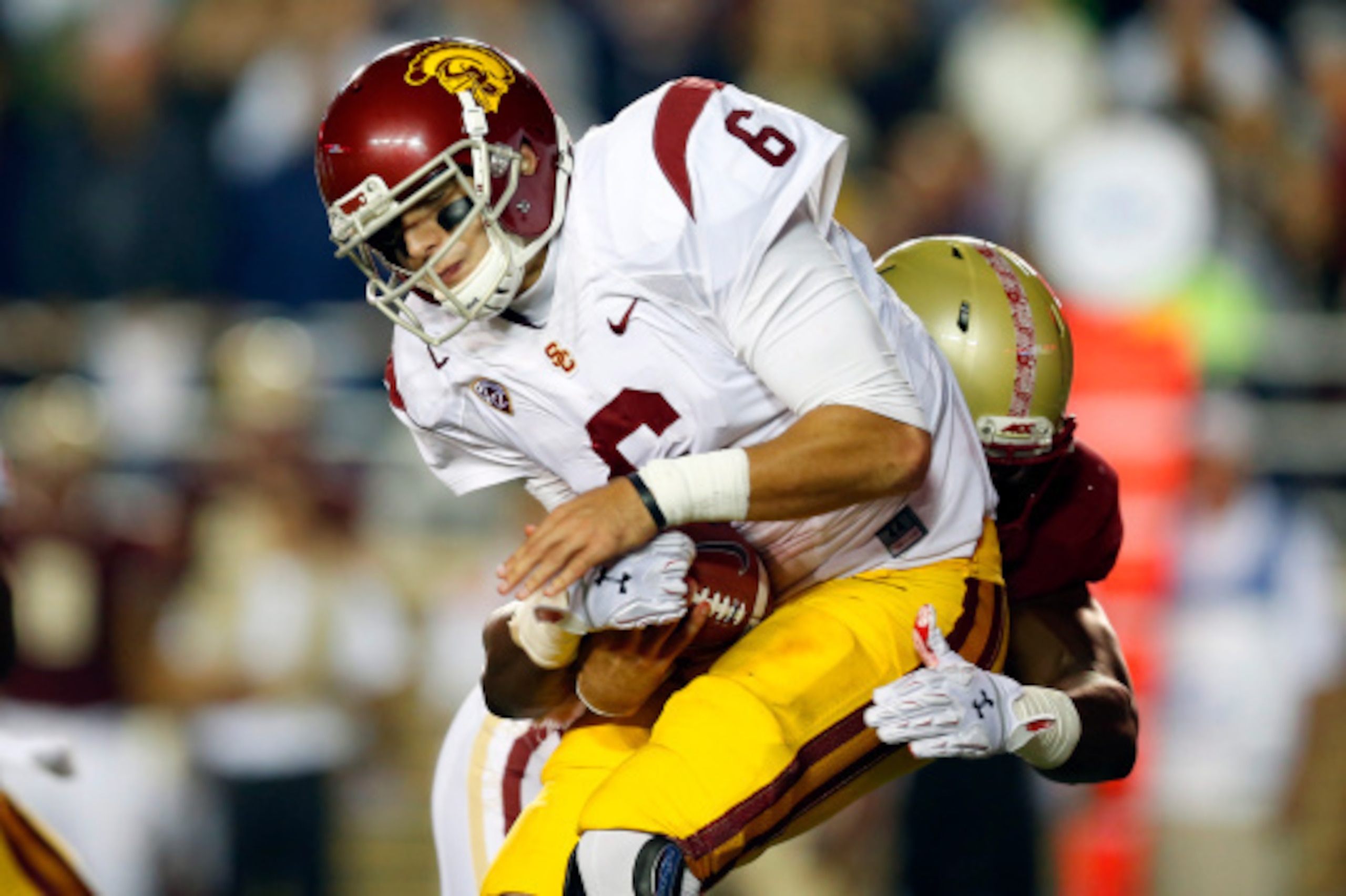 BOSTON, MA- SEPTEMBER 13:  Quarterback Cody Kessler #6 of the USC Trojans is sacked by defensive end Seyi Adebayo #95 of the Boston College Eagles during the second half of BC's 37-31 win at Alumni Stadium on September 13 in Chestnut Hill, Massachusetts. 