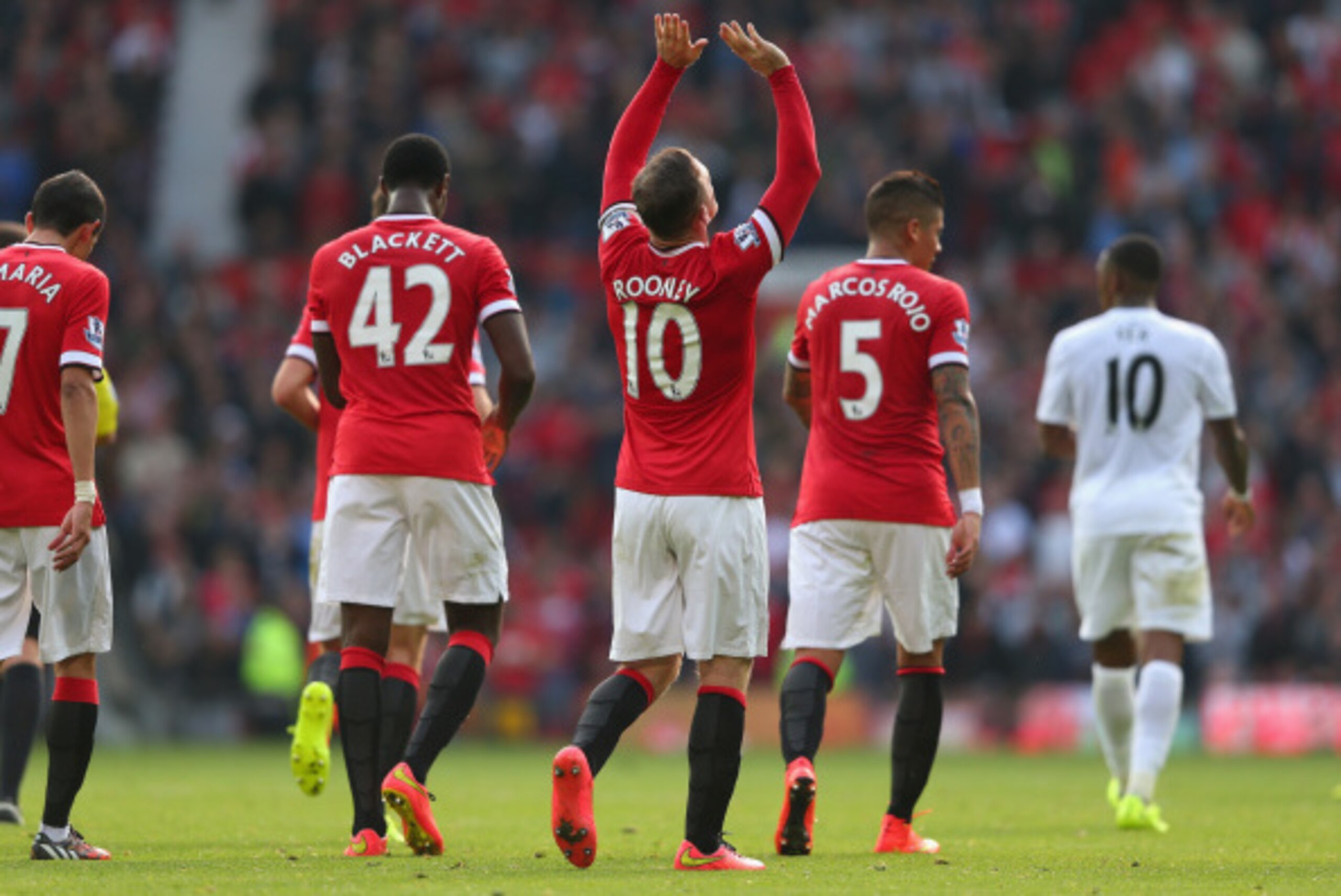 MANCHESTER, ENGLAND - SEPTEMBER 14:  Wayne Rooney of Manchester United celebrates scoring the third goal during the Barclays Premier League match between Manchester United and Queens Park Rangers at Old Trafford on September 14, 2014 in Manchester, Englan