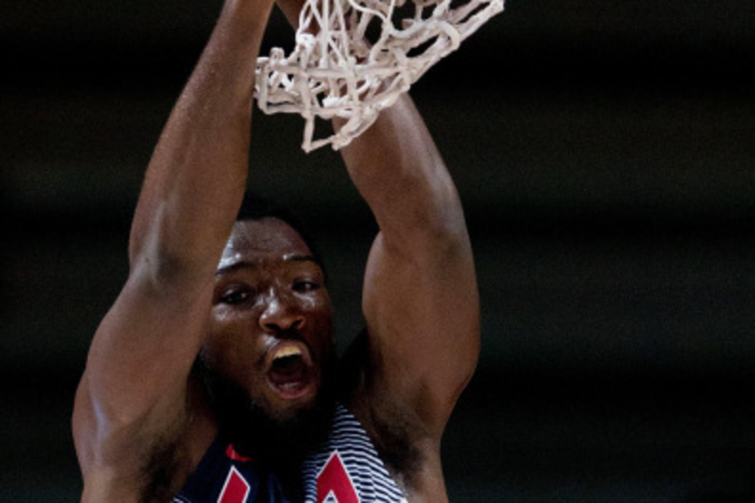 MADRID, SPAIN - SEPTEMBER 14: Kenneth Faried of the USA hangs from the basket after scoring during the 2014 FIBA World Basketball Championship final match between USA and Serbia at Palacio de los Deportes on September 14, 2014 in Madrid, Spain.  (Photo by