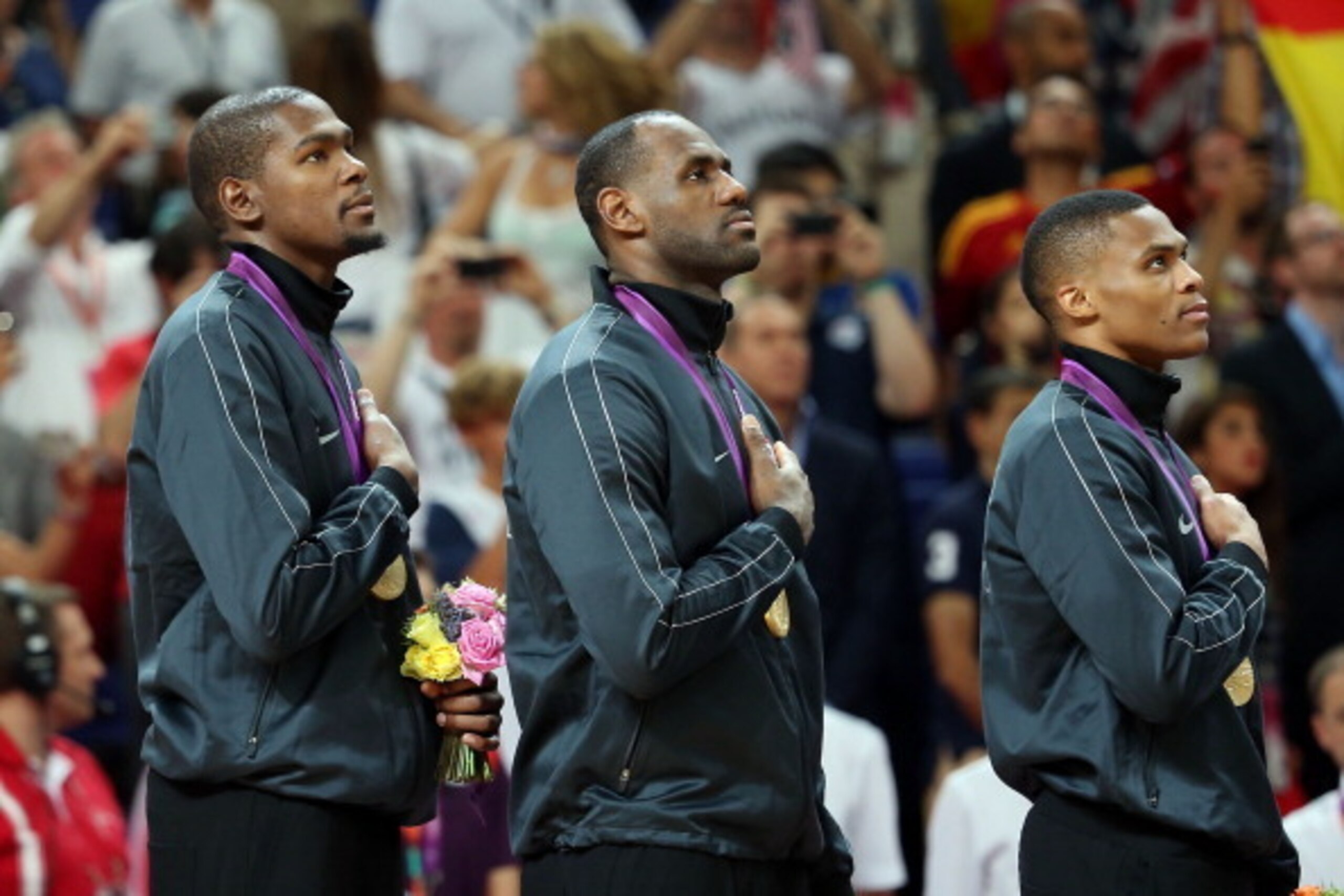 LONDON, ENGLAND - AUGUST 12:  Kevin Durant #5, Lebron James #6 and Russell Westbrook #7 of United States stand for National Anthem following the Men's Basketball gold medal game against Spain on Day 16 of the London 2012 Olympics Games at North Greenwich 