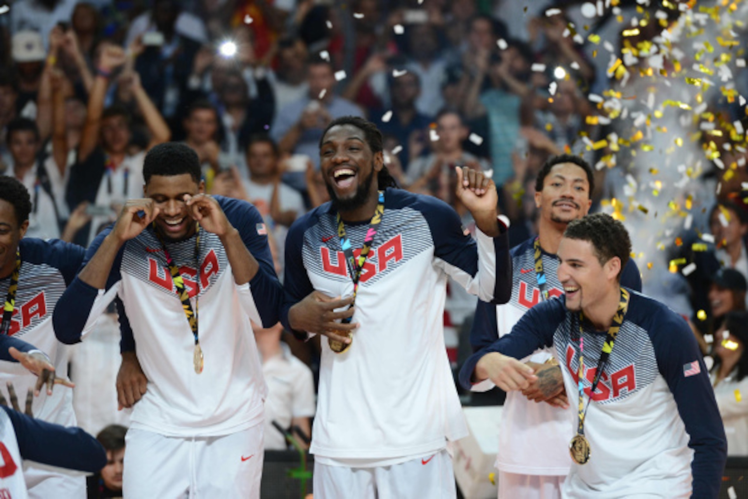 MADRID, SPAIN - SEPTEMBER 14: Kenneth Faried of the USA Men's National Team celebrates on the podium with the World Cup after defeating the Serbia National Team in the 2014 FIBA World Cup Finals at Palacio de Deportes on September 14, 2014 in Madrid, Spai