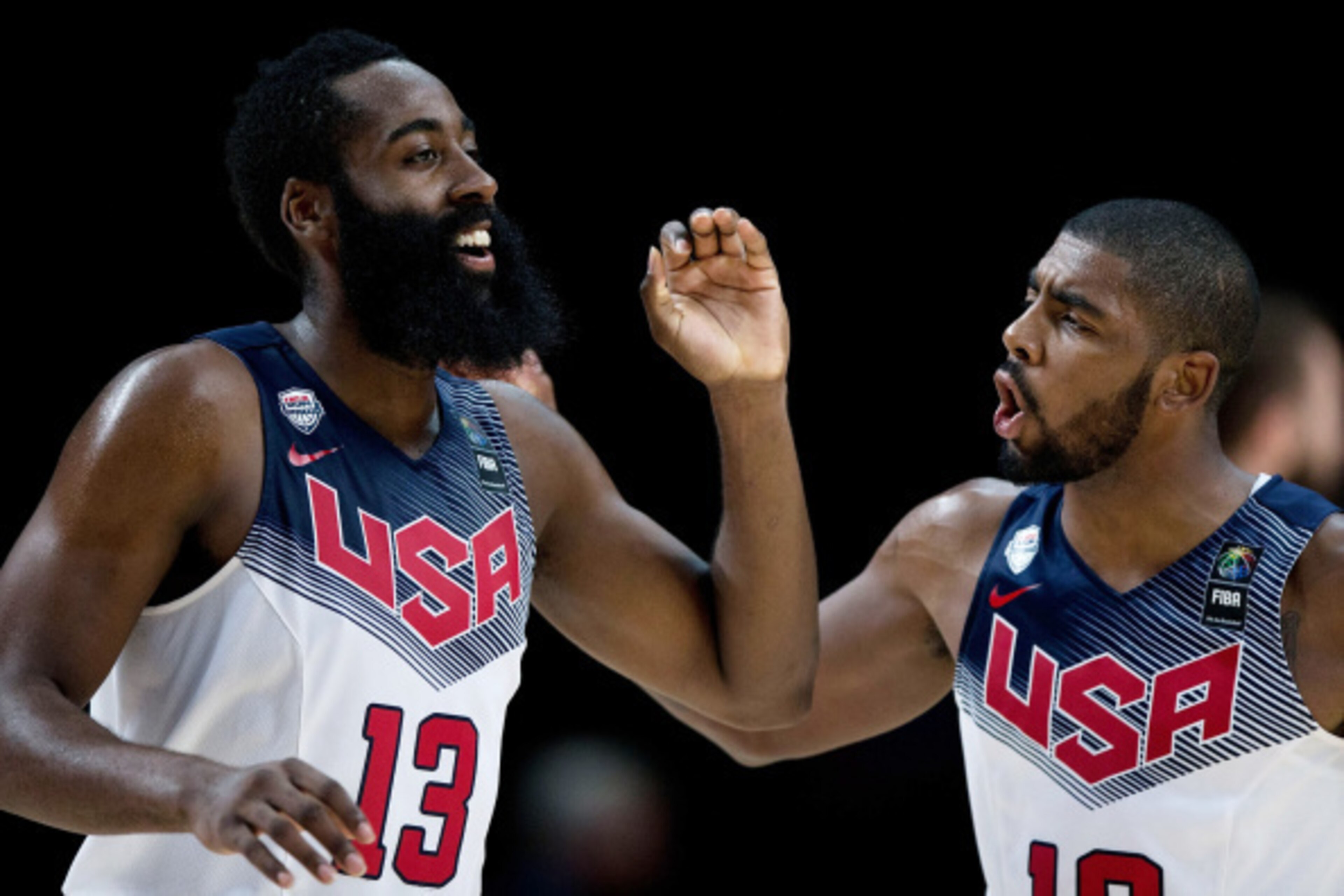 MADRID, SPAIN - SEPTEMBER 14: James Harden (L) of the USA celebrates scoring with teammate Kyrie Irving (R) during the 2014 FIBA World Basketball Championship final match between USA and Serbia at Palacio de los Deportes on September 14, 2014 in Madrid, S