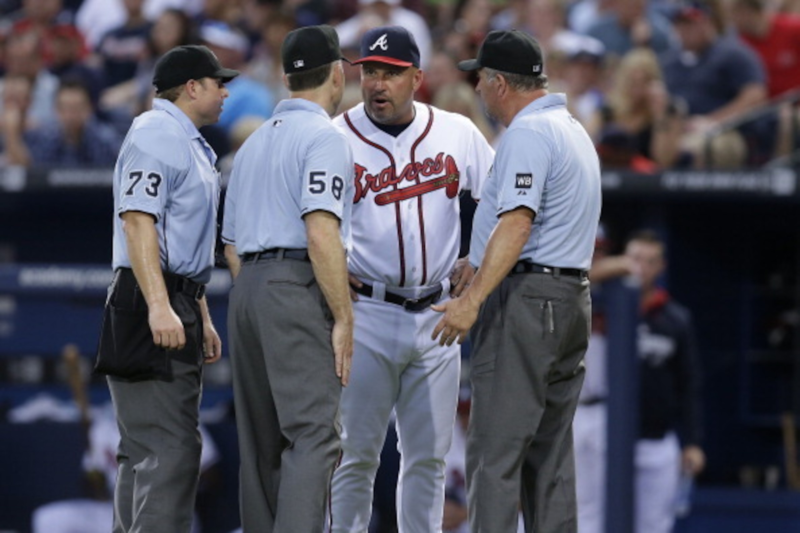 ATLANTA, GA - JUNE 30:  Manager Fredi Gonzalez #33 of the Atlanta Braves argues a call with umpires Hal Gibson #73, Dan Iassogna #58 and Dale Scott #5 during the game against the New York Mets at Turner Field on June 30, 2014 in Atlanta, Georgia.  (Photo 